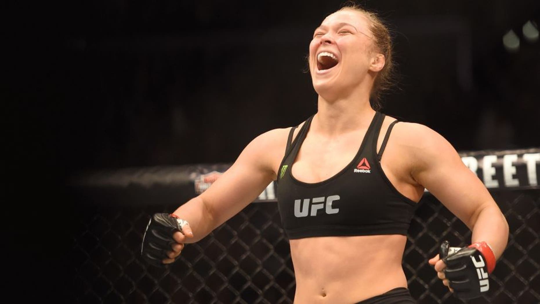 Ronda Rousey celebrates her victory over Cat Zingano in their UFC women's bantamweight championship bout during the UFC 184 event at Staples Center on February 28, 2015 in Los Angeles, California. (Photo by Harry How/Getty Images)