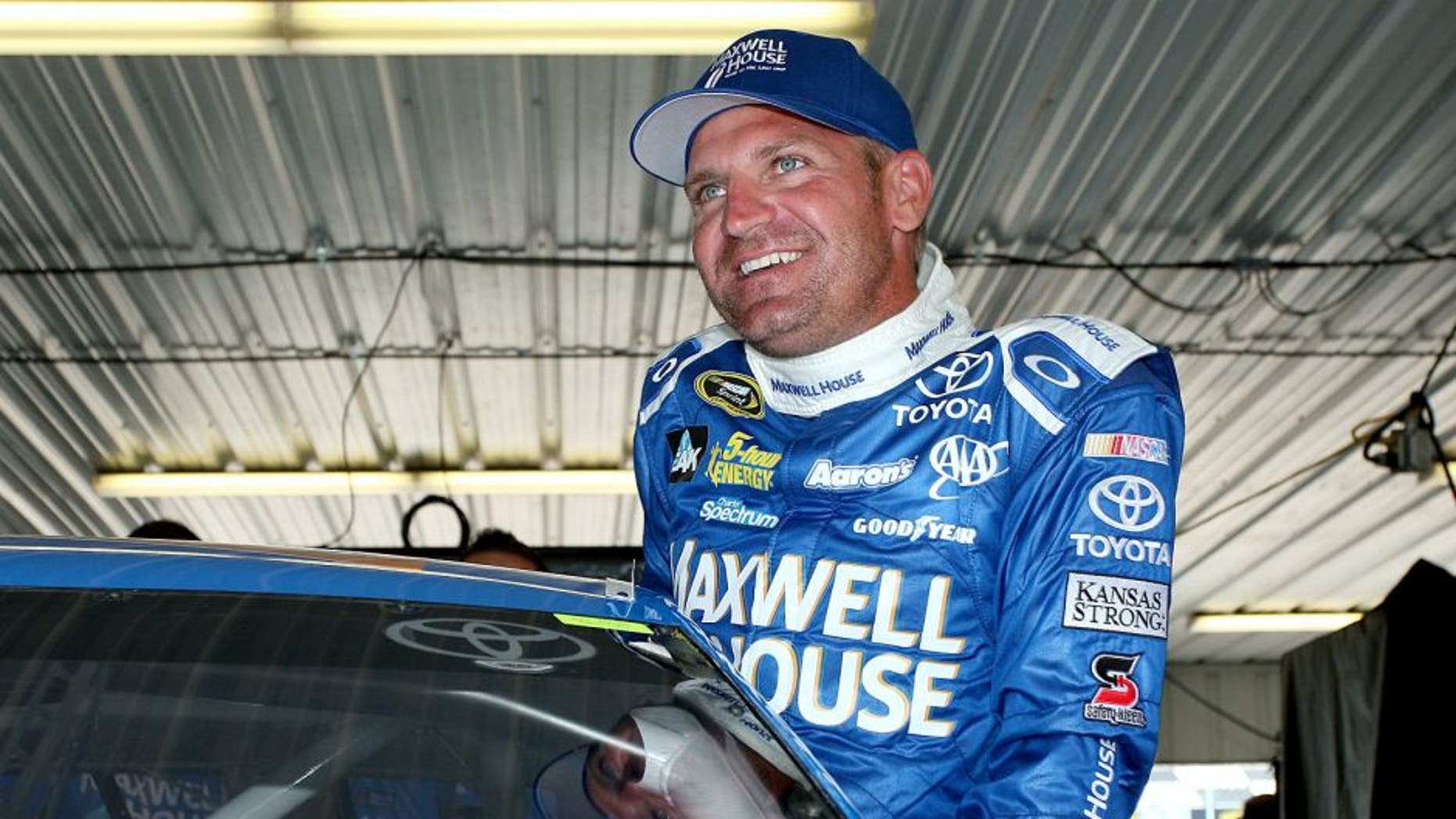 LONG POND, PA - JULY 31: Clint Bowyer, driver of the #15 Maxwell House Toyota, gets in his car in the garage during practice for the NASCAR Sprint Cup Series Windows 10 400 at Pocono Raceway on July 31, 2015 in Long Pond, Pennsylvania. (Photo by Tim Bradbury/Getty Images)