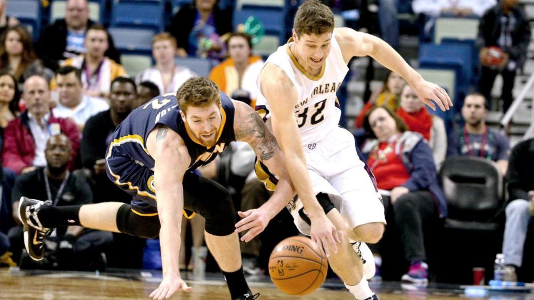 Feb 11, 2015; New Orleans, LA, USA; New Orleans Pelicans guard Jimmer Fredette (32) and Indiana Pacers forward Shayne Whittington (42) scramble for a loose ball during the second half of a game at the Smoothie King Center. The Pacers defeated the Pelicans 106-93.Mandatory Credit: Derick E. Hingle-USA TODAY Sports