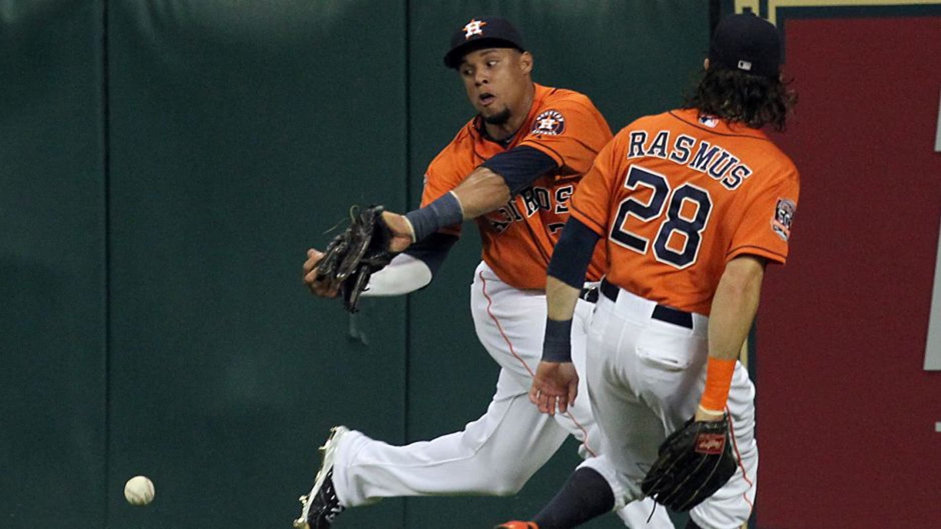 Jul 31, 2015; Houston, TX, USA; Houston Astros center fielder Carlos Gomez collides with left fielder Colby Rasmus (28) while chasing down Arizona Diamondbacks catcher Welington Castillo (not pictured) double in the sixth inning at Minute Maid Park. Mandatory Credit: Thomas B. Shea-USA TODAY Sports