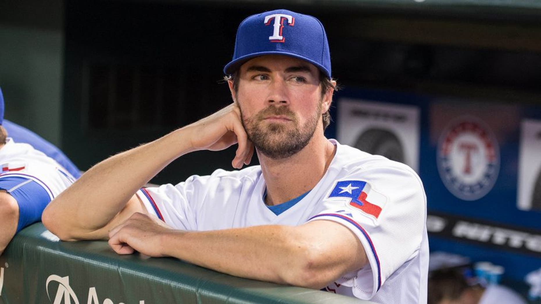 Jul 31, 2015; Arlington, TX, USA; Texas Rangers starting pitcher Cole Hamels (35) watches his new team take on the San Francisco Giants at Globe Life Park in Arlington. The Rangers defeated the Giants 6-3. Mandatory Credit: Jerome Miron-USA TODAY Sports