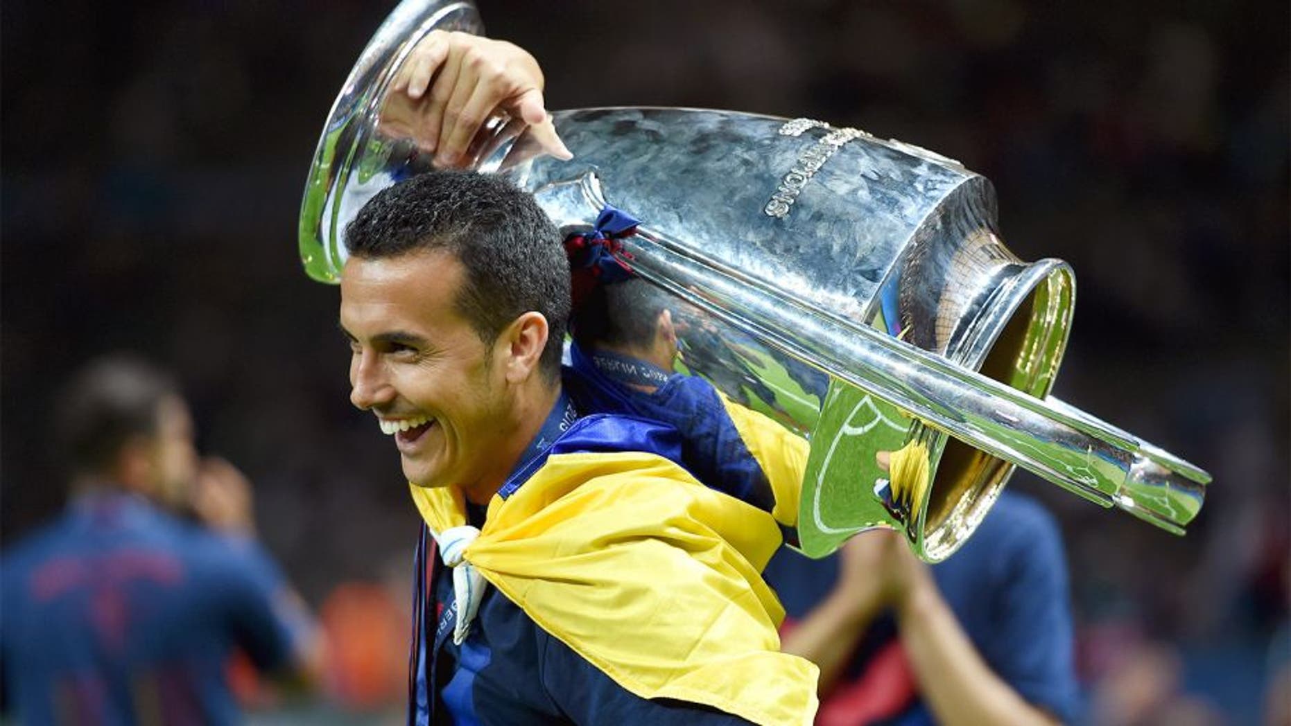 BERLIN, GERMANY - JUNE 06: Pedro of Barcelona celebrates with the trophy after the UEFA Champions League Final between Juventus and FC Barcelona at Olympiastadion on June 6, 2015 in Berlin, Germany. (Photo by Matthias Hangst/Getty Images)