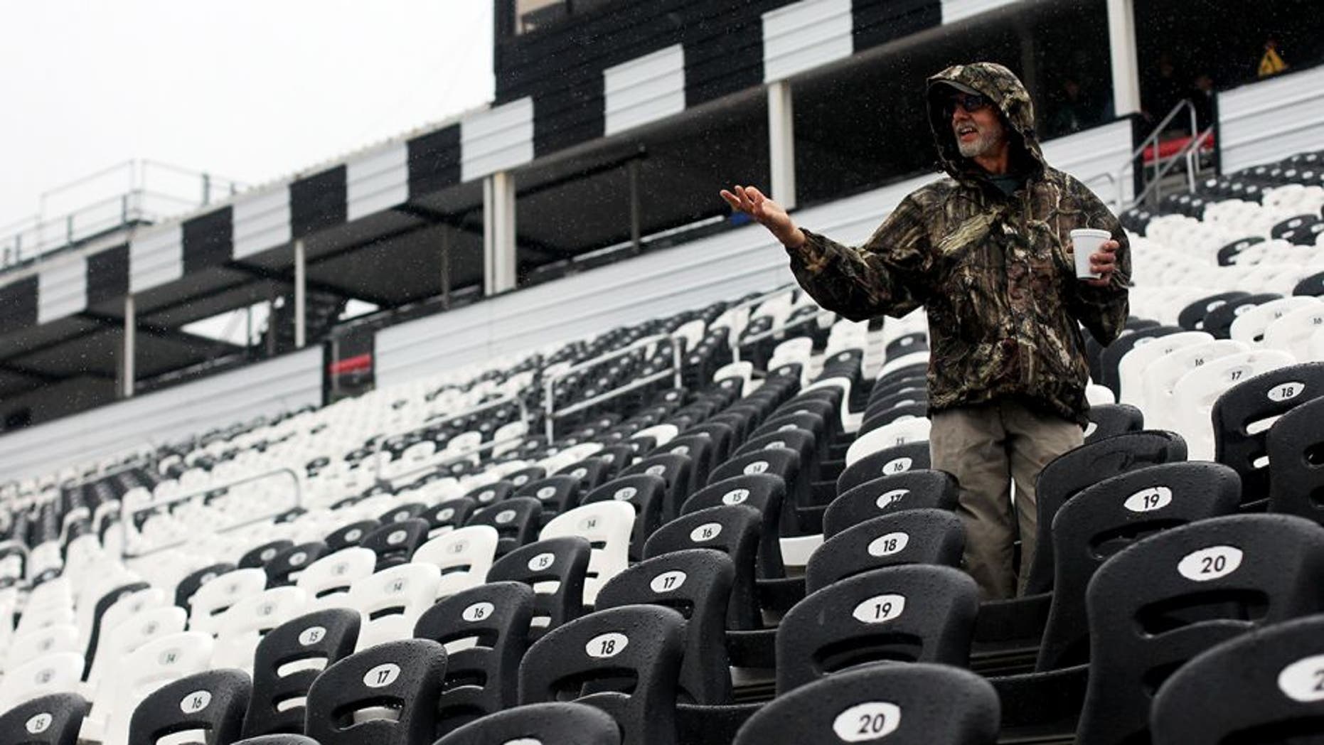 LONG POND, PA - JULY 31: Race fans walk in the rain prior to the NASCAR Sprint Cup Series Pennsylvania 400 at Pocono Raceway on July 31, 2016 in Long Pond, Pennsylvania. (Photo by Adam Glanzman/Getty Images)