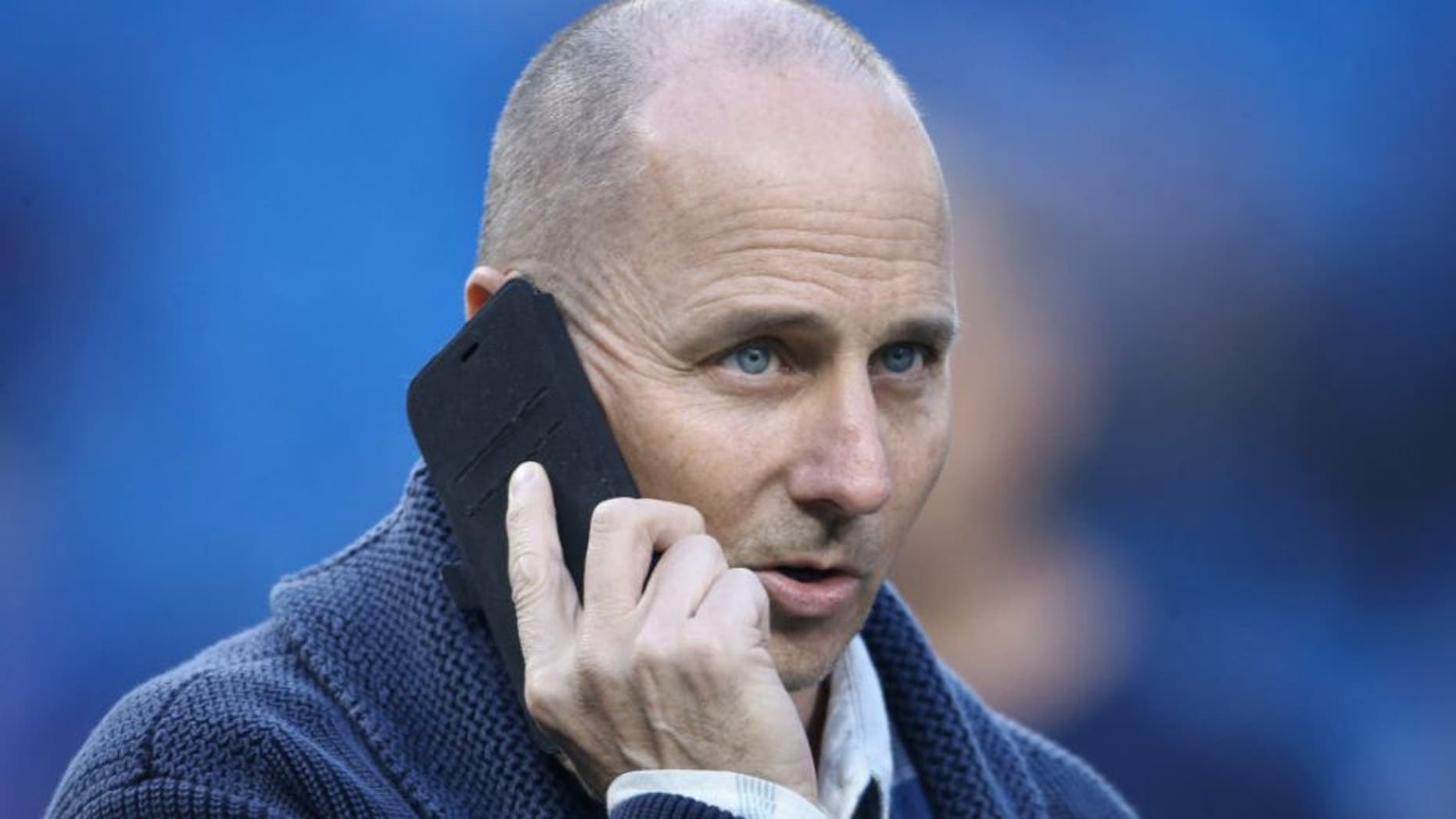 TORONTO, CANADA - SEPTEMBER 21: General manager Brian Cashman of the New York Yankees talks on the phone during batting practice before the start of MLB game action against the Toronto Blue Jays on September 21, 2015 at Rogers Centre in Toronto, Ontario, Canada. (Photo by Tom Szczerbowski/Getty Images)