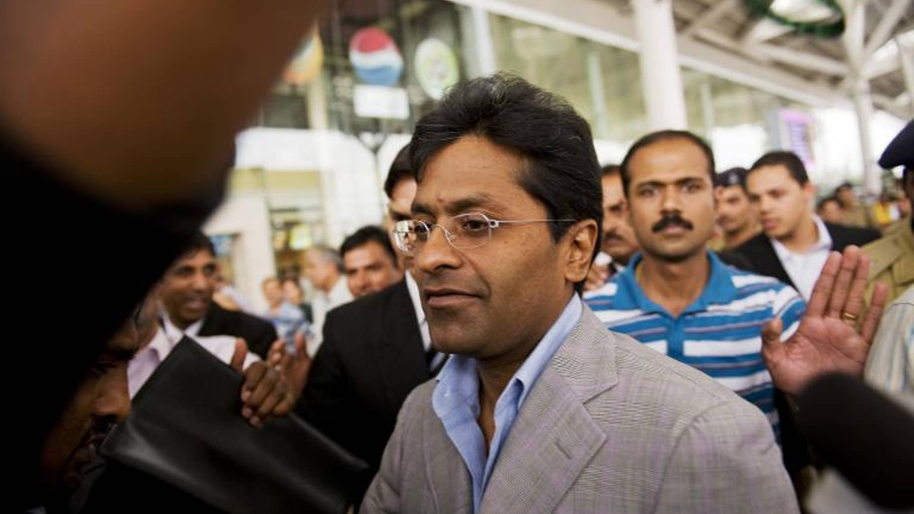 Suspended Indian Premier League (IPL) Chairman Lalit Modi (C) is seen at Indira Gandhi International Airport in New Delhi on April 28, 2010