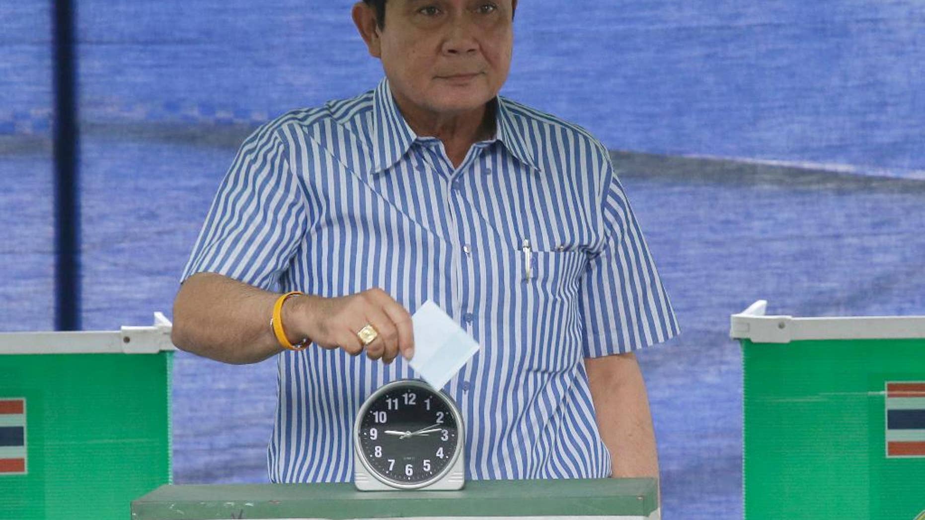 Thailand's Prime Minister Prayuth Chan-ocha poses as he casts his vote in a referendum on a new constitution at a polling station in Bangkok, Thailand, Sunday, Aug. 7, 2016. Thais voted Sunday in a referendum on a new constitution that critics say is tailor-made for the military government to stay in control for several years and entrench a new, quasi-democratic system that gives vast powers to appointed officials. (AP Photo/Sakchai Lalit)