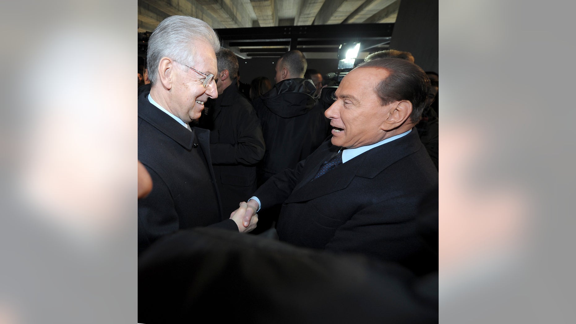 Italian Premier Mario Monti, left, and former Premier Silvio Berlusconi shake hands in Milan, Italy, Sunday, Jan. 27, 2013. Silvio Berlusconi says Benito Mussolini did much good, except for dictator's regime's anti-Jewish laws. Berlusconi also defended Mussolini for siding with Hitler, saying the late fascist leader likely reasoned that German power would expand so it would be better for Italy to ally itself with Germany. He was speaking to reporters Sunday on the sidelines of a ceremony in Milan to commemorate the Holocaust. When Germany's Nazi regime occupied Italy during World War II, thousands from the tiny Italian Jewish community were deported to death camps. In 1938, before the war's outbreak, Mussolini's regime passed anti-Jewish laws, barring them from universities and many professions, among other bans. Berlusconi called the laws Mussolini's "worst fault" but insisted that in many other things, "he did good." (AP Photo/Antonio Calanni)