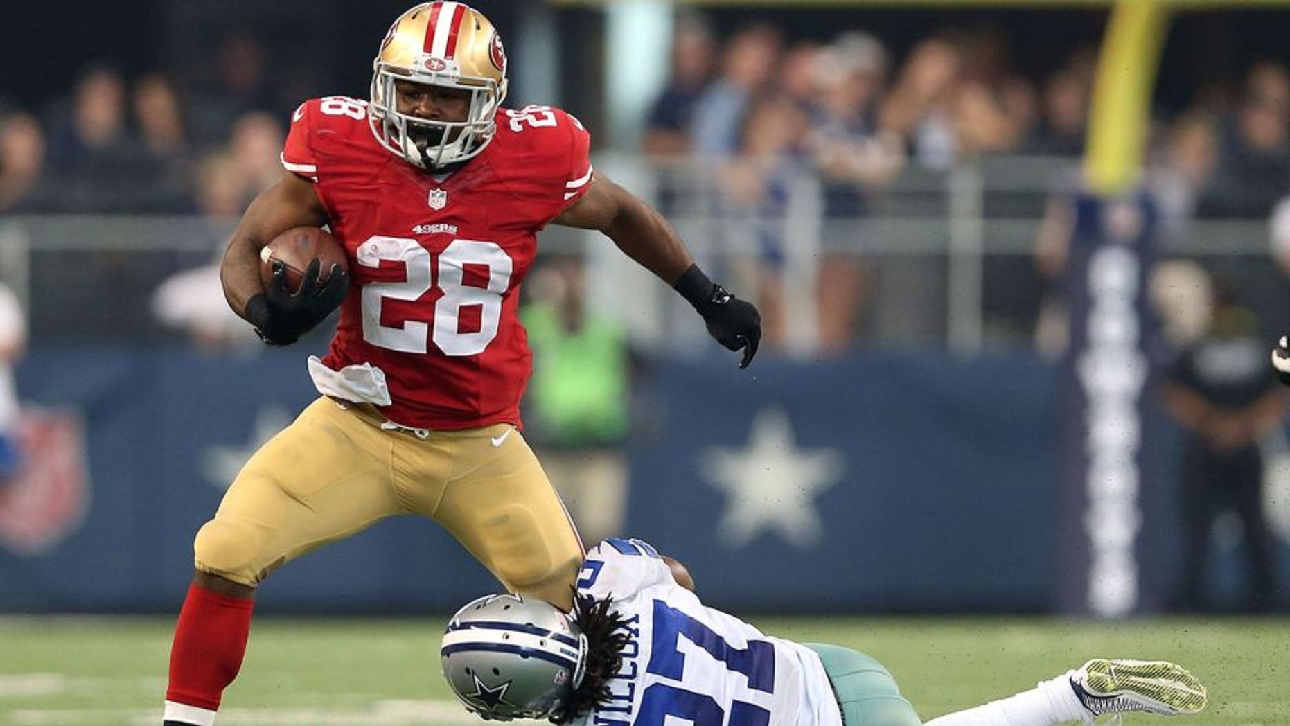 ARLINGTON, TX - SEPTEMBER 07: Carlos Hyde #28 of the San Francisco 49ers tries to break from the grasp of J.J. Wilcox #27 of the Dallas Cowboys in the second half at AT&T Stadium on September 7, 2014 in Arlington, Texas. (Photo by Christian Petersen/Getty Images)