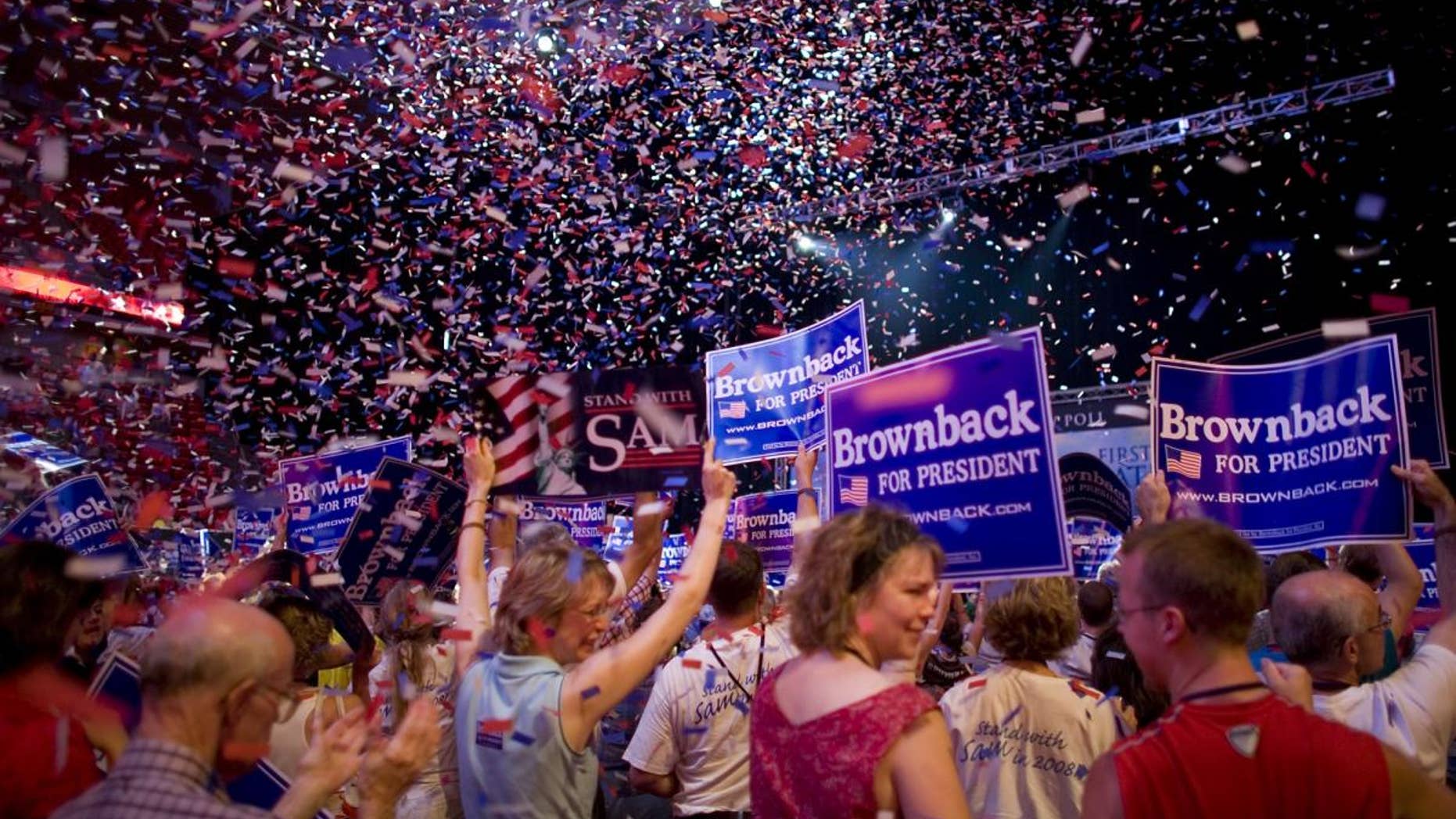 FILE -- Supporters of presidential hopeful U.S. Sen. Sam Brownback, R-Kan., cheer as confetti falls after Brownback finished speaking at the Iowa Straw Poll in Ames, Iowa, Saturday, Aug 11, 2007. (AP File Photo/David Lienemann)