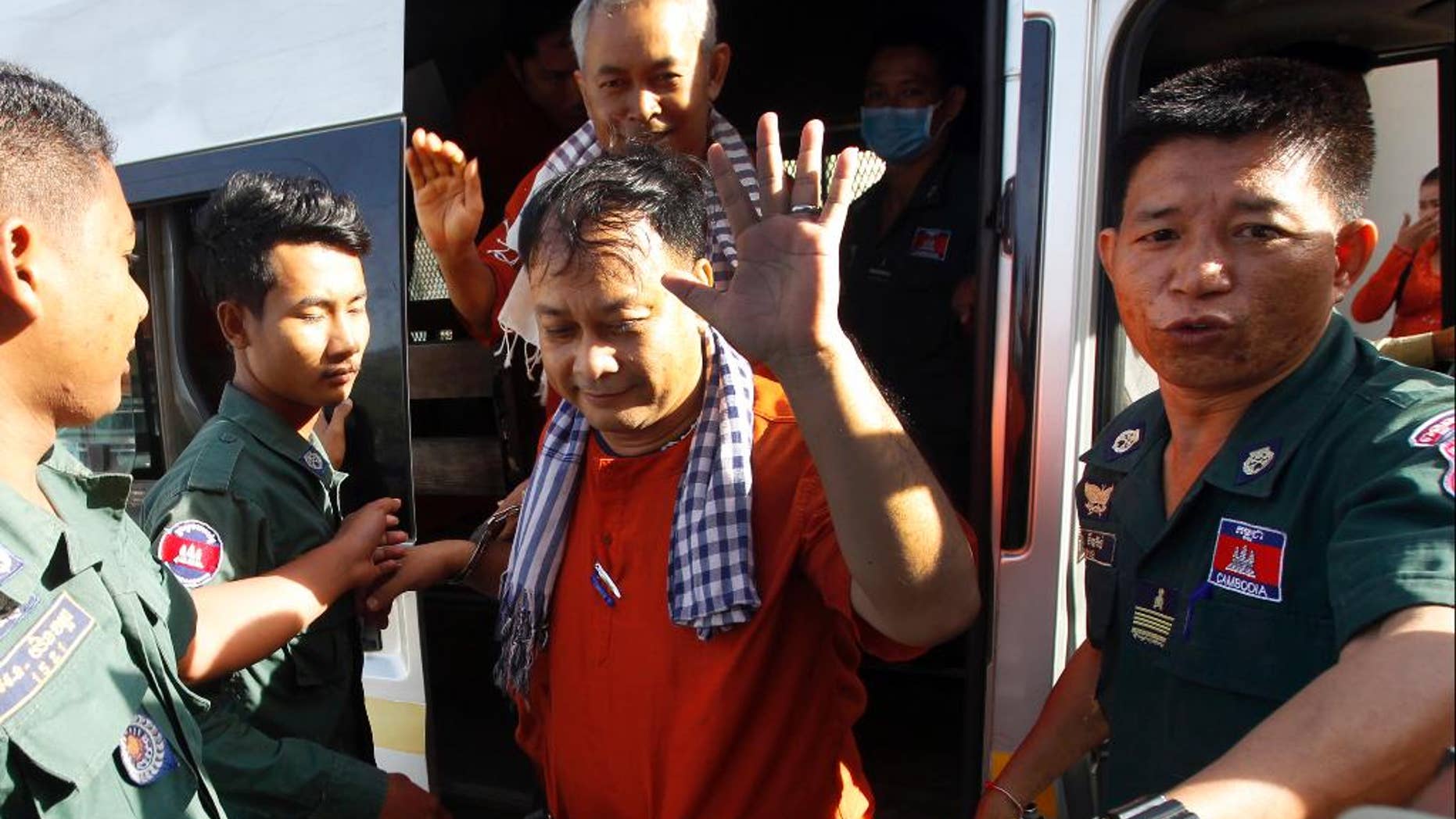FILE - Wednesday, Nov. 30, 2016, file photo, Ny Vanda, center, and Yi Soksan, rear center, staff members of Cambodia Human Rights and Development Association (ADHOC) arrive at Supreme Court, in Phnom Penh, Cambodia. The United States has joined the European Union and U.N. human rights agencies in expressing concern over the extended pre-trial detention of five Cambodian human rights held for more than a year. (AP Photo/Heng Sinith, File)