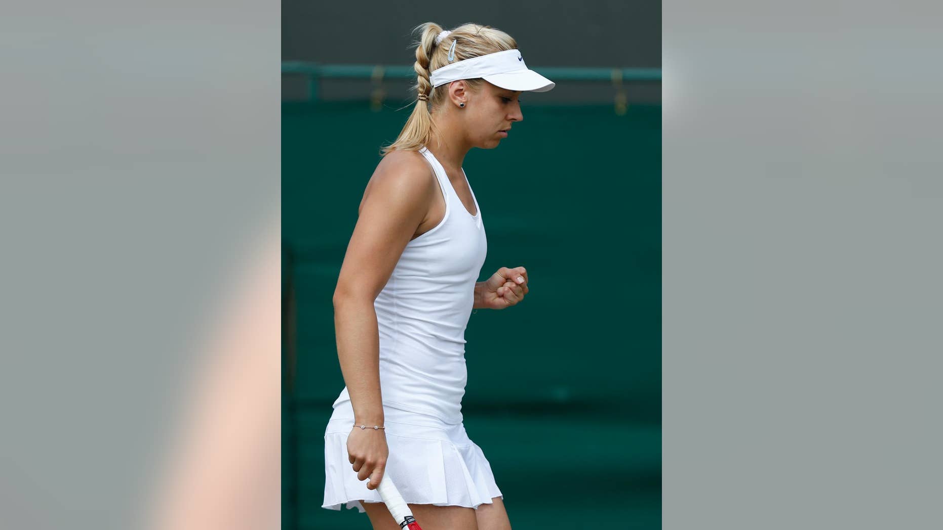 Sabine Lisicki of Germany celebrates a point during the women's singles match against Yaroslava Shvedova of Kazakhstan at the All England Lawn Tennis Championships in Wimbledon, London, Tuesday, July 1, 2014. (AP Photo/Sang Tan)