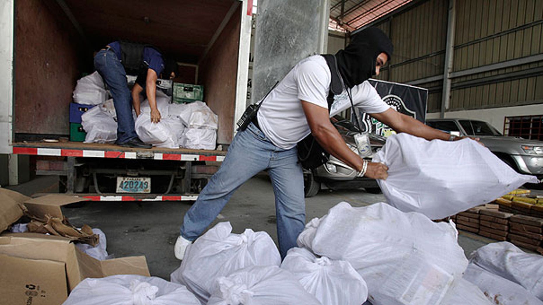 Aug. 1: Anti-narcotic agents unload sacks containing packages of heroin during a press conference in Panama City.