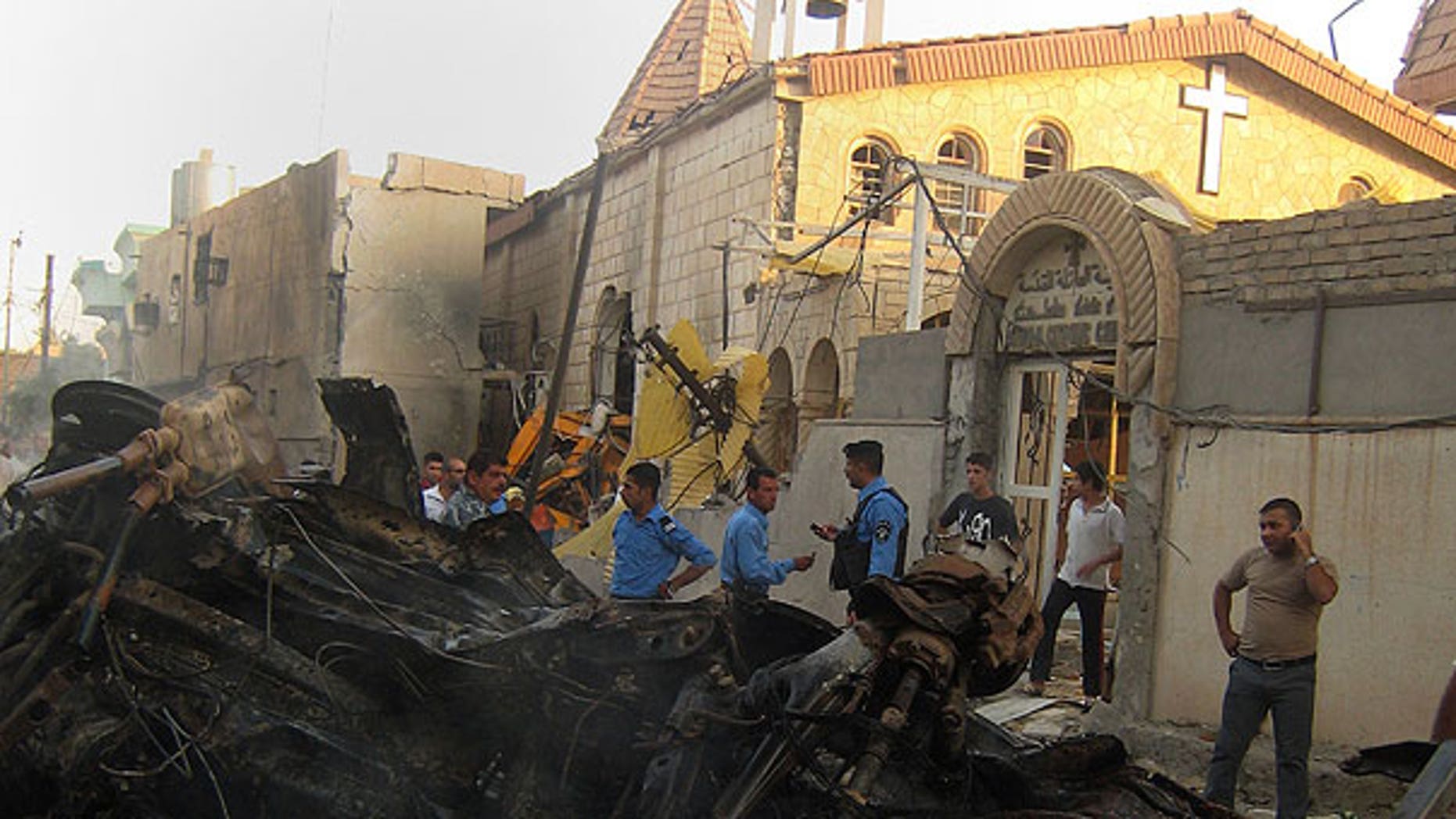 Aug. 2: Iraqis inspect the site of an early morning car bomb attack in front of a Church in Kirkuk, 180 miles north of Baghdad, Iraq.