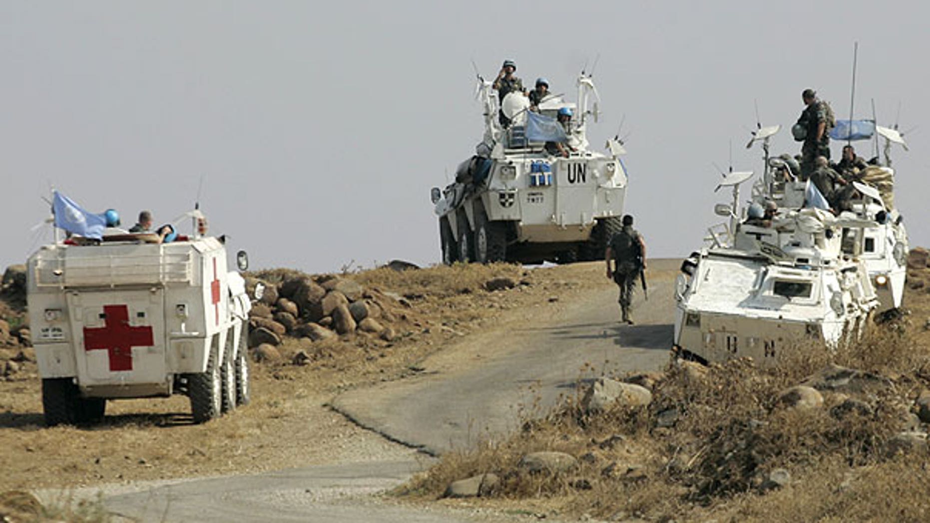 Aug. 1: Spanish United Nations peacekeepers atop armored vehicles patrol the border in the southeastern Wazzani River area, Lebanon.