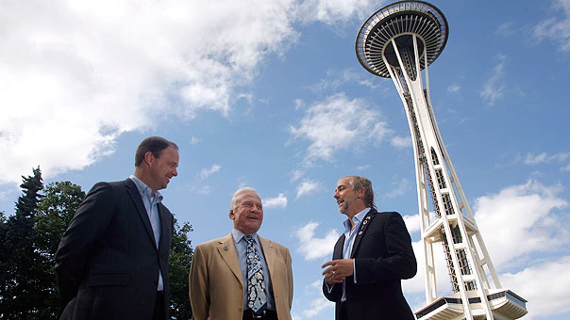 July 31: Buzz Aldrin, former astronaut (center), and Richard Garriott, first second-generation space traveler (right), talk about space exploration outside the Space Needle in Seattle as Ron Sevart, CEO of the Space Needle, listens in.