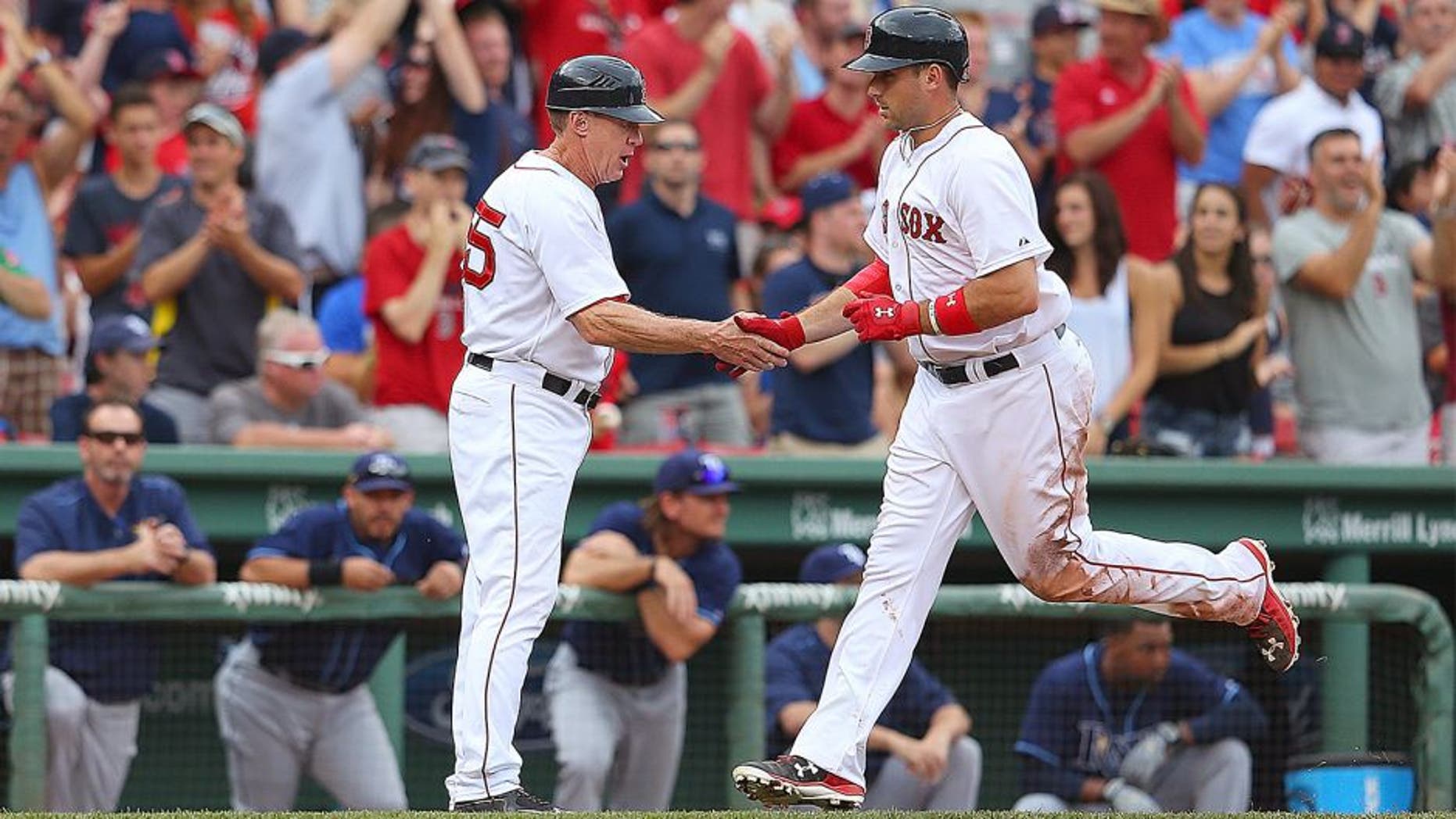 BOSTON, MA - AUGUST 1: Travis Shaw #47 of the Boston Red Sox celebrates with third base coach Brian Butterfield #55 of the Boston Red Sox after his second home run against the Tampa Bay Rays in the eighth inning at Fenway Park on August 1, 2015 in Boston, Massachusetts. (Photo by Jim Rogash/Getty Images)
