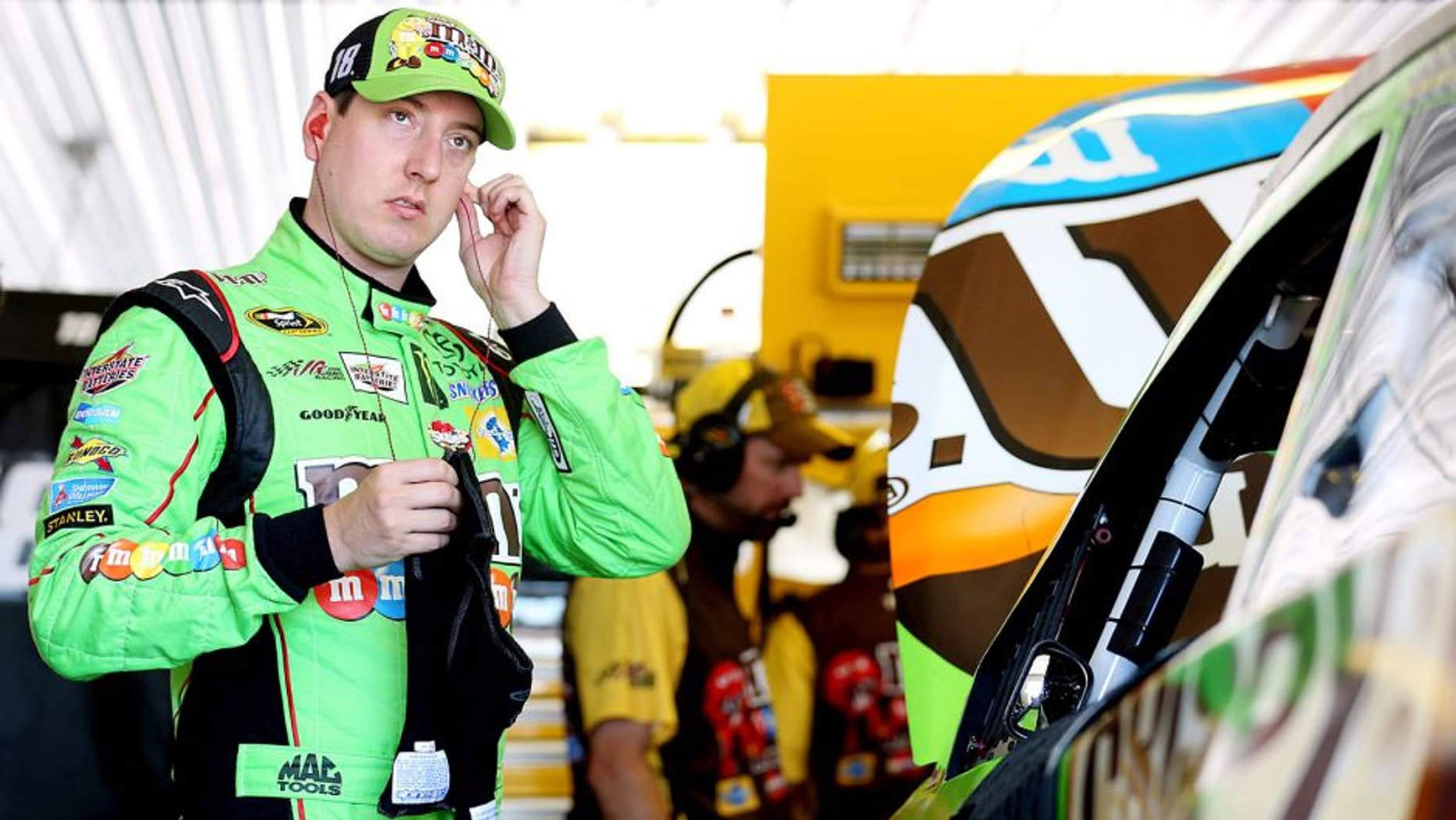 LONG POND, PA - JULY 31: Kyle Busch, driver of the #18 M&M's Crispy Toyota, stands in the garage during practice for the NASCAR Sprint Cup Series Windows 10 400 at Pocono Raceway on July 31, 2015 in Long Pond, Pennsylvania. (Photo by Nick Laham/Getty Images)