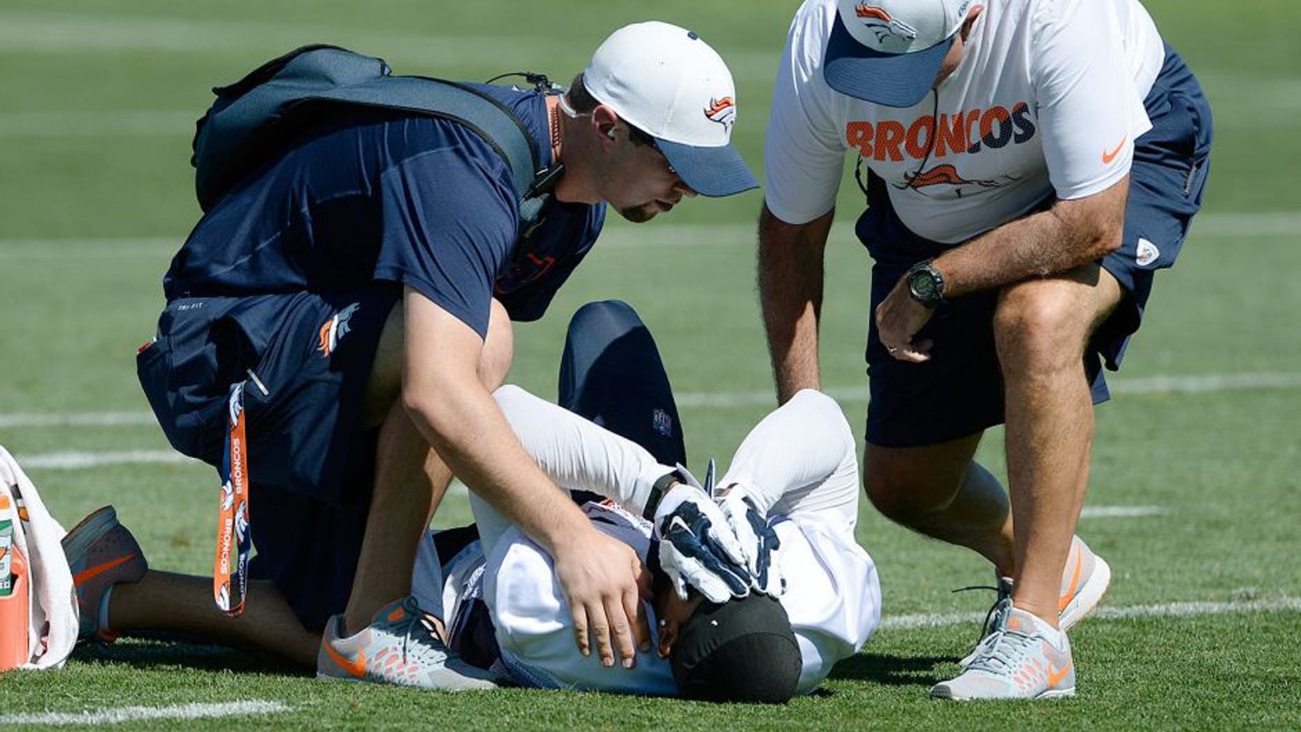 CENTENNIAL,CO - AUGUST 01: Denver Broncos WR Kyle Williams is tended to after an injury during training camp at Dove Valley August 01, 2015. Williams was later carted off the field with an unknown injury. (Photo by Andy Cross/The Denver Post via Getty Images)
