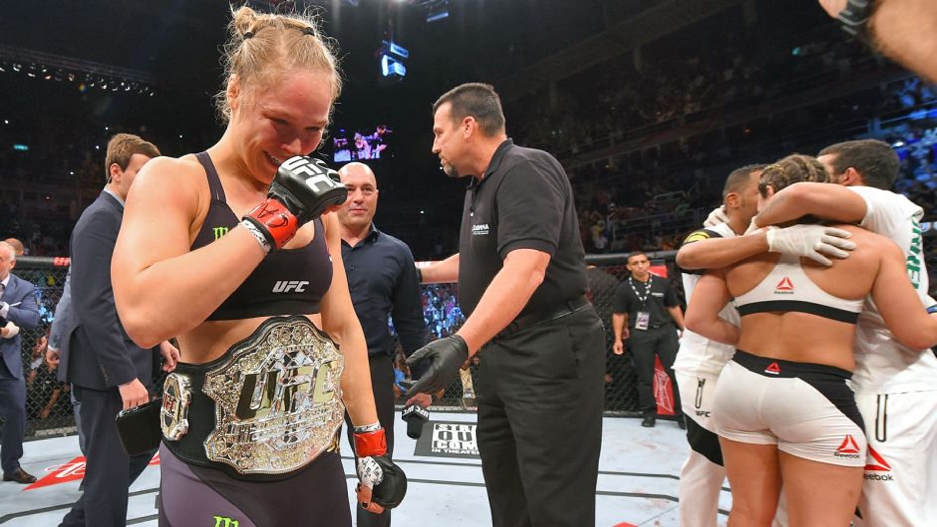 RIO DE JANEIRO, BRAZIL - AUGUST 01: (L-R) Ronda Rousey of the United States celebrates her knock out victory over Bethe Correia of Brazil in the first round in their UFC women's bantamweight championship bout during the UFC 190 event inside HSBC Arena on August 1, 2015 in Rio de Janeiro, Brazil. (Photo by Josh Hedges/Zuffa LLC/Zuffa LLC via Getty Images)