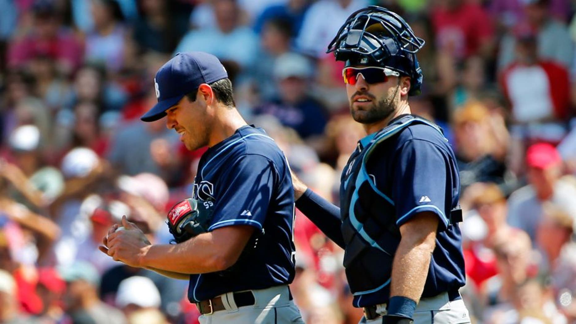 Tampa Bay Rays starting pitcher Matt Moore gets a pat on the back from catcher Curt Casali after giving up a run to the Boston Red Sox during the second inning of a baseball game at Fenway Park in Boston Saturday, Aug. 1, 2015. (AP Photo/Winslow Townson)