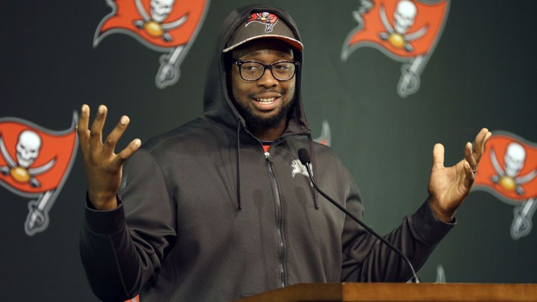 Tampa Bay Buccaneers defensive tackle Gerald McCoy gestures while speaking to reporters during an NFL football training camp news conference Saturday, Aug. 1, 2015, in Tampa, Fla. The first day of the team's training camp was canceled due to inclement weather. (AP Photo/Chris O'Meara)