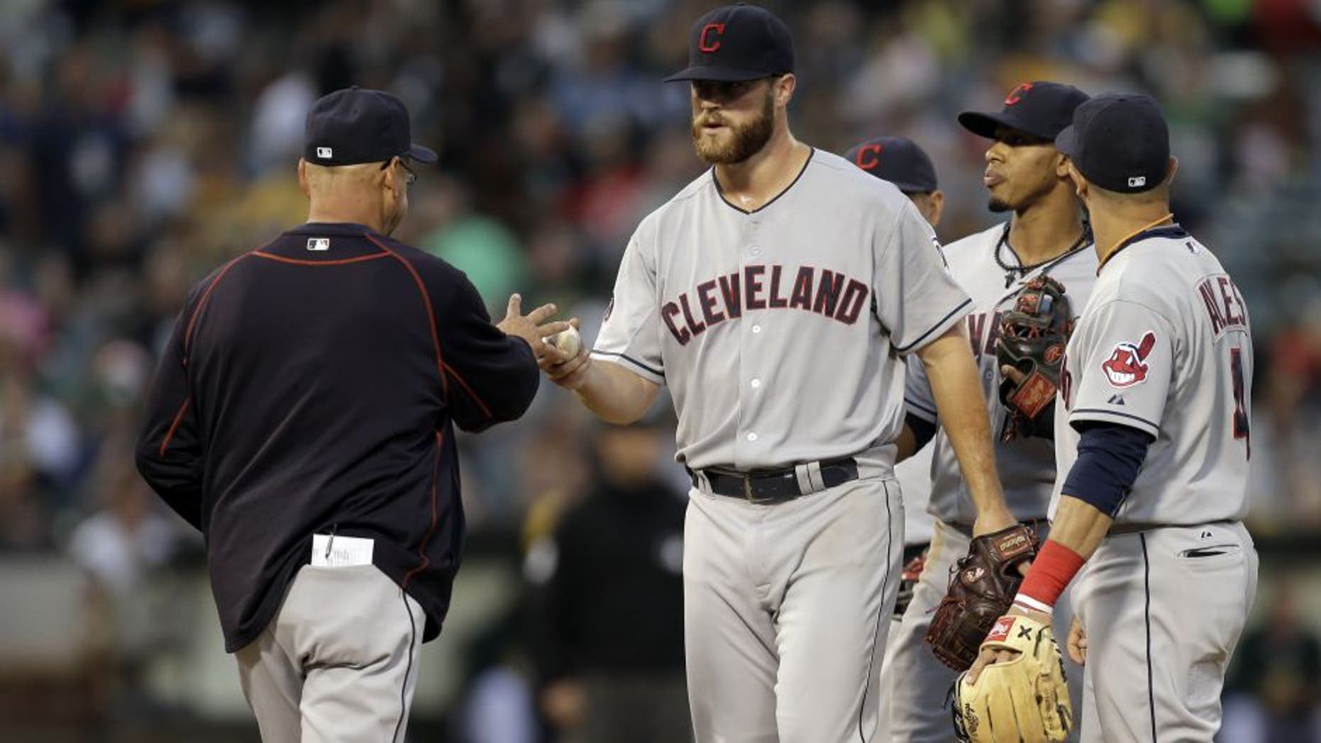 Cleveland Indians' Cody Anderson, center, hands the ball to manager Terry Francona after being removed in the seventh inning of a baseball game against the Oakland Athletics, Saturday, Aug. 1, 2015, in Oakland, Calif.