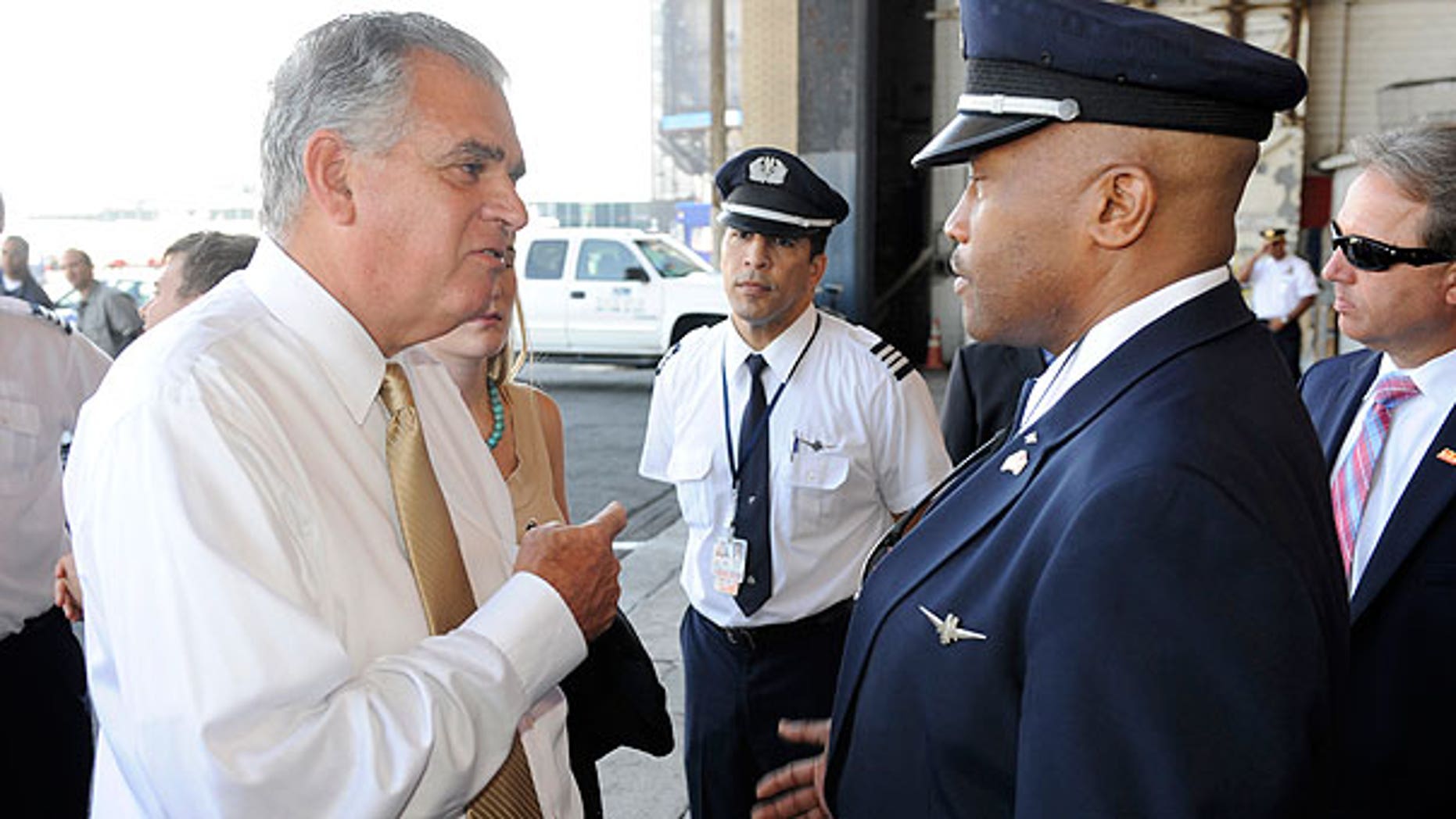 Aug. 1: U.S. Transportation Secretary Ray LaHood, left, talks to American Airlines pilot Jesse J. Perkins after a news conference at which LaHood spoke of the interruption of federal funding for airport construction projects and contractors, at LaGuardia Airport in New York.