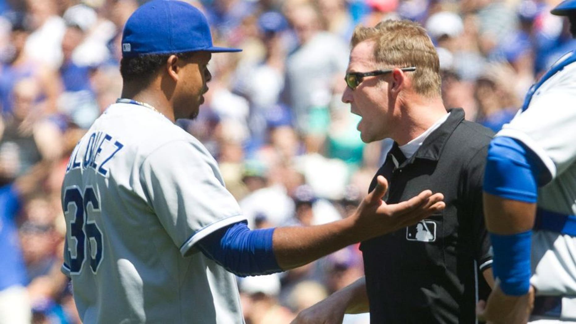 Kansas City Royals starting pitcher Edinson Volquez is given a warning by home plate umpire Jim Wolf after brushing Toronto Blue Jays' Josh Donaldson back with a pitch during the third inning of a baseball game against the Kansas City Royals in Toronto, Sunday Aug. 2, 2015. (Fred Thornhill/The Canadian Press via AP)