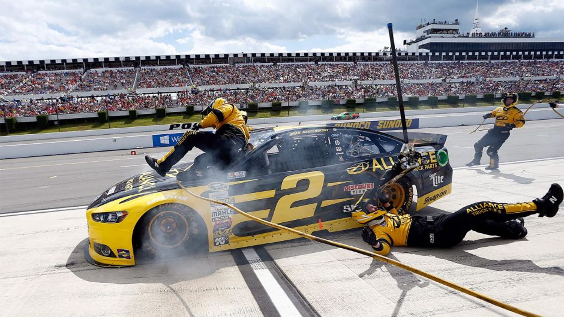 LONG POND, PA - AUGUST 02: Brad Keselowski, driver of the #2 Alliance Truck Parts Ford, crashes into his crew on pit road during the NASCAR Sprint Cup Series Windows 10 400 at Pocono Raceway on August 2, 2015 in Long Pond, Pennsylvania. (Photo by Jeff Zelevansky/NASCAR via Getty Images)