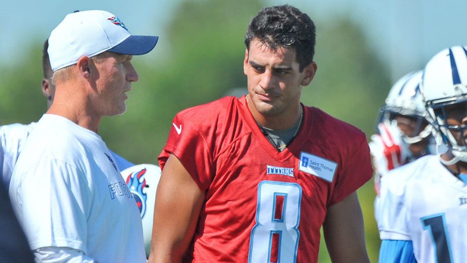 Jul 31, 2015; Nashville, TN, USA; Tennessee Titans head coach Ken Whisenhunt with Titans starting quarterback Marcus Mariota (8) during the first day of training camp at Saint Thomas Sports Park. Mandatory Credit: Jim Brown-USA TODAY Sports