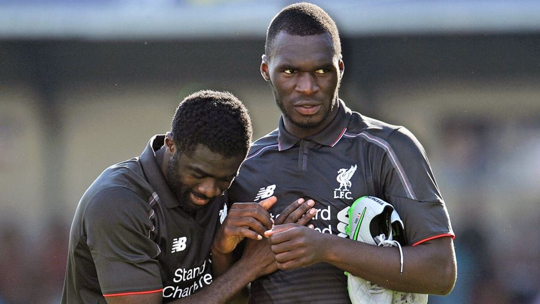 SWINDON, ENGLAND - AUGUST 02: (THE SUN OUT, THE SUN ON SUNDAY OUT) Christian Benteke and Kolo Toure of Liverpool show their appreciation to the fans at the end of a preseason friendly at County Ground on August 2, 2015 in Swindon, England. (Photo by Andrew Powell/Liverpool FC via Getty Images)