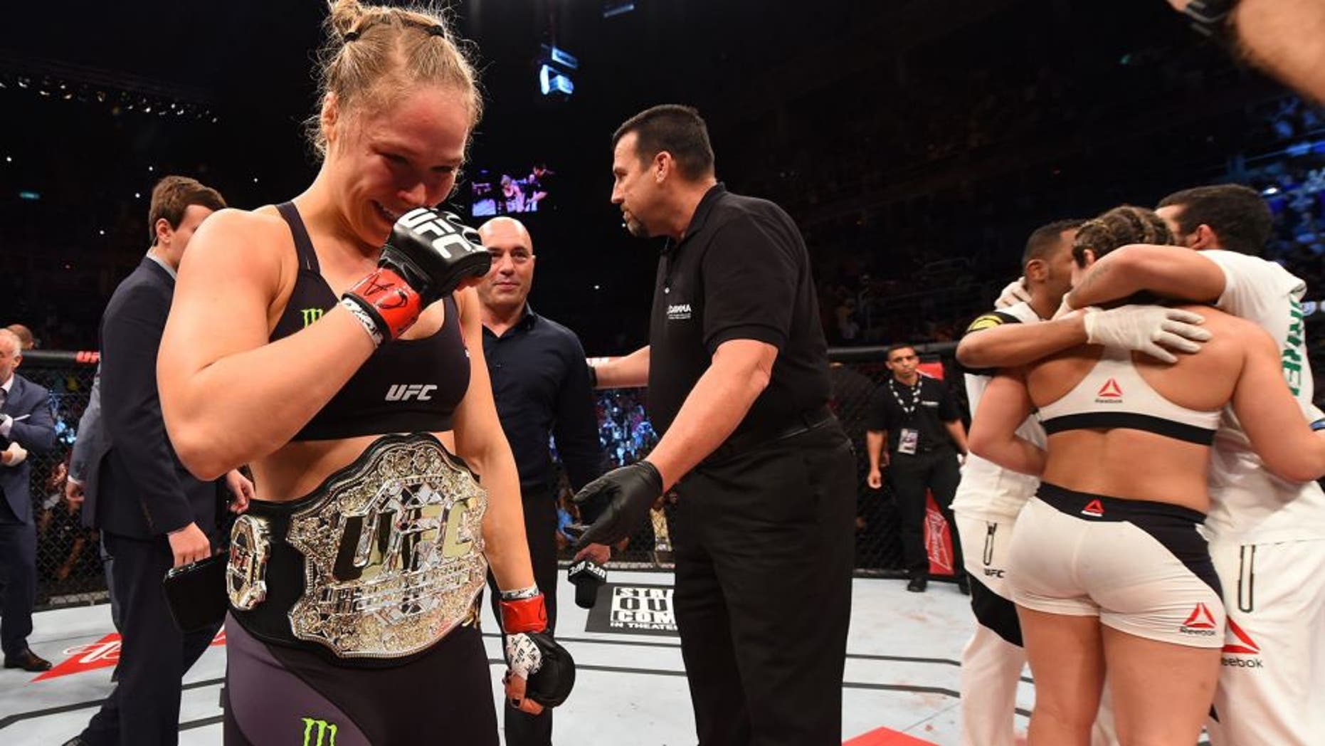 RIO DE JANEIRO, BRAZIL - AUGUST 01: (L-R) Ronda Rousey of the United States celebrates her knock out victory over Bethe Correia of Brazil in the first round in their UFC women's bantamweight championship bout during the UFC 190 event inside HSBC Arena on August 1, 2015 in Rio de Janeiro, Brazil. (Photo by Josh Hedges/Zuffa LLC/Zuffa LLC via Getty Images)