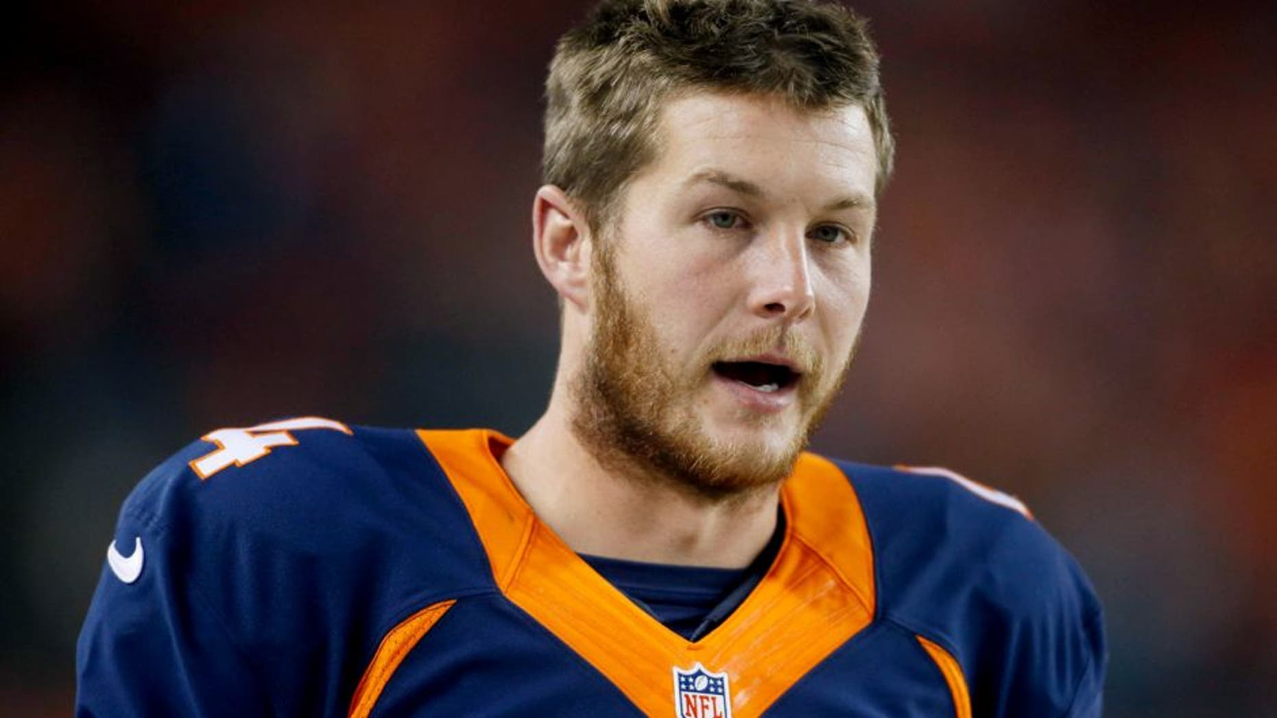 Oct 19, 2014; Denver, CO, USA; Denver Broncos punter Britton Colquitt (4) during the game against the San Francisco 49ers at Sports Authority Field at Mile High. Mandatory Credit: Chris Humphreys-USA TODAY Sports