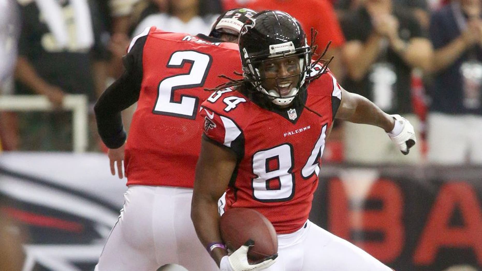 Sep 7, 2014; Atlanta, GA, USA; Atlanta Falcons wide receiver Roddy White (84) celebrates his touchdown with Atlanta Falcons quarterback Matt Ryan (2) in the first half of their game against the New Orleans Saints at the Georgia Dome. The Falcons won 37-34 in overtime. Mandatory Credit: Jason Getz-USA TODAY Sports