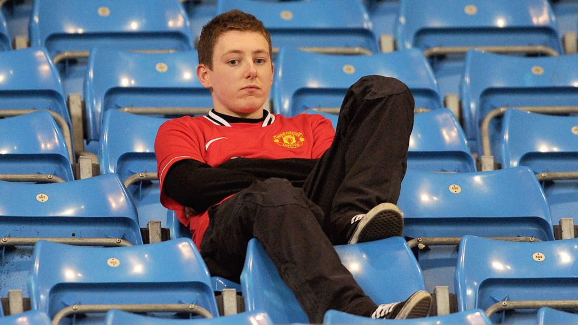 MANCHESTER, ENGLAND - APRIL 30: A Manchester United fan looks dejected at the end of the Barclays Premier League match between Manchester City and Manchester United at the Etihad Stadium on April 30, 2012 in Manchester, England. (Photo by Michael Regan/Getty Images)
