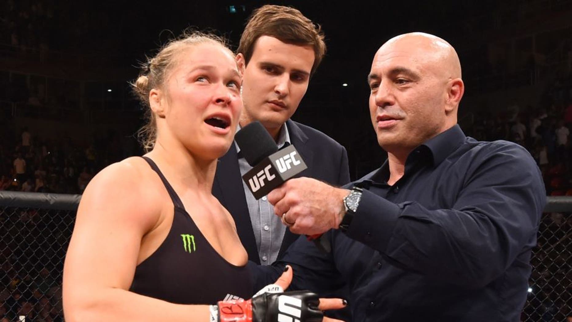 RIO DE JANEIRO, BRAZIL - AUGUST 01: (L-R) Ronda Rousey of the United States speaks to Joe Rogan after her knock out victory over Bethe Correia of Brazil in the first round in their UFC women's bantamweight championship bout during the UFC 190 event inside HSBC Arena on August 1, 2015 in Rio de Janeiro, Brazil. (Photo by Josh Hedges/Zuffa LLC/Zuffa LLC via Getty Images)