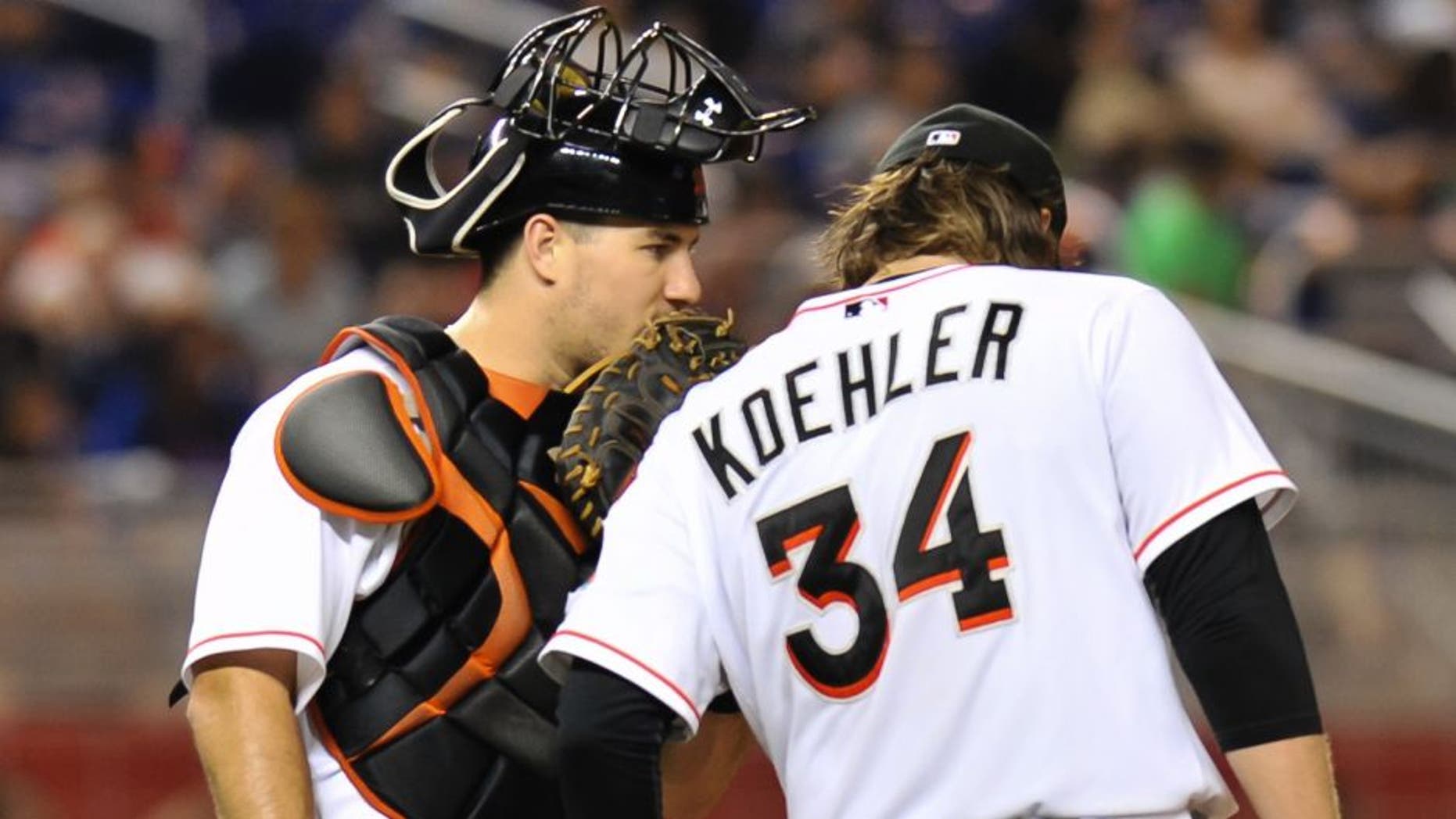 Aug 3, 2015; Miami, FL, USA; Miami Marlins catcher J.T. Realmuto (left) talks with starting pitcher Tom Koehler (right) on the pitchers mound during the fourth inning against the New York Mets at Marlins Park. Mandatory Credit: Steve Mitchell-USA TODAY Sports