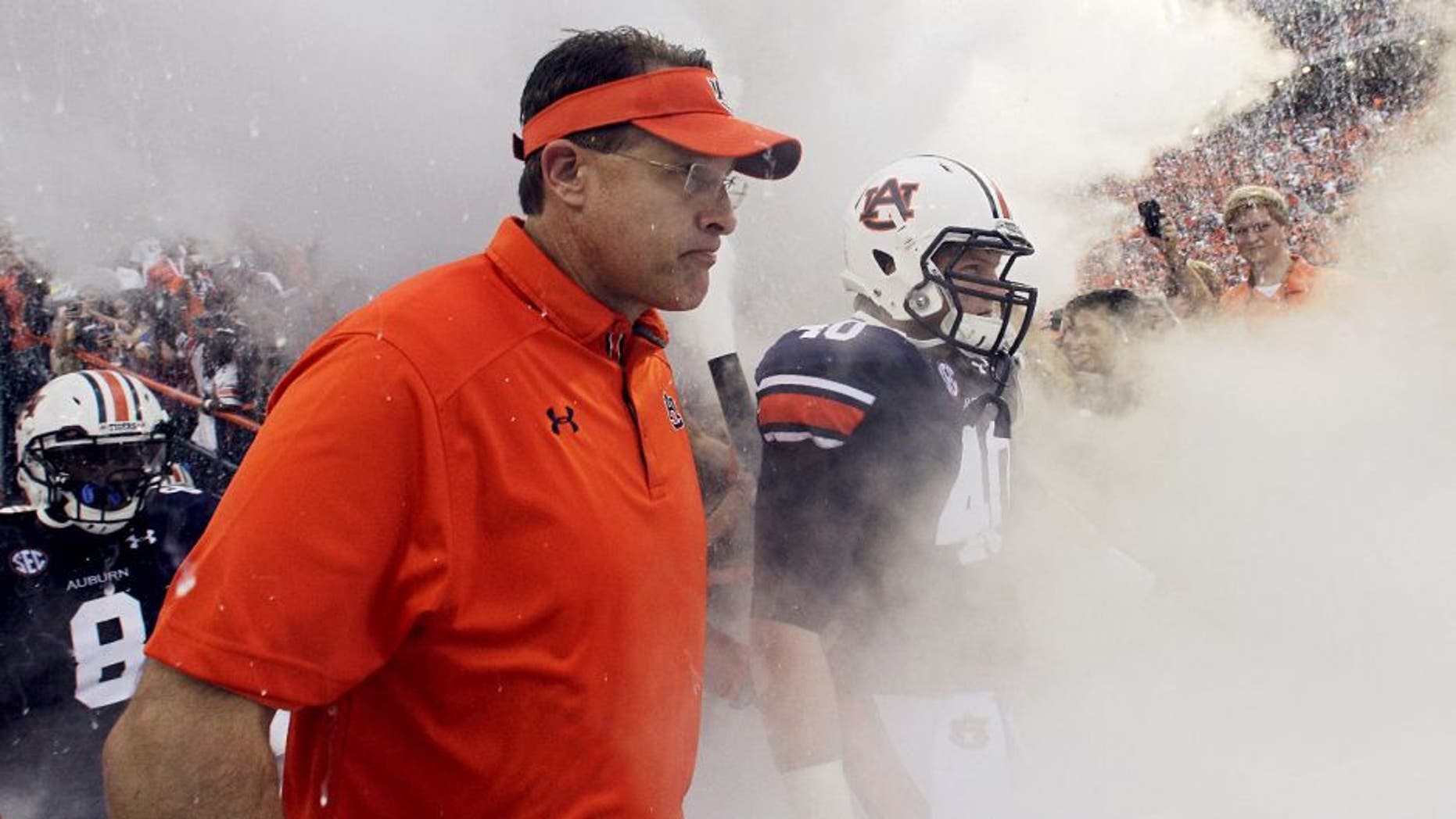 Aug 31, 2013; Auburn, AL, USA; Auburn Tigers head coach Gus Malzahn and his team enter the field at Jordan Hare Stadium for the game against the Washington State Cougars. The Tigers beat the Cougars 31-24. Mandatory Credit: John Reed-USA TODAY Sports