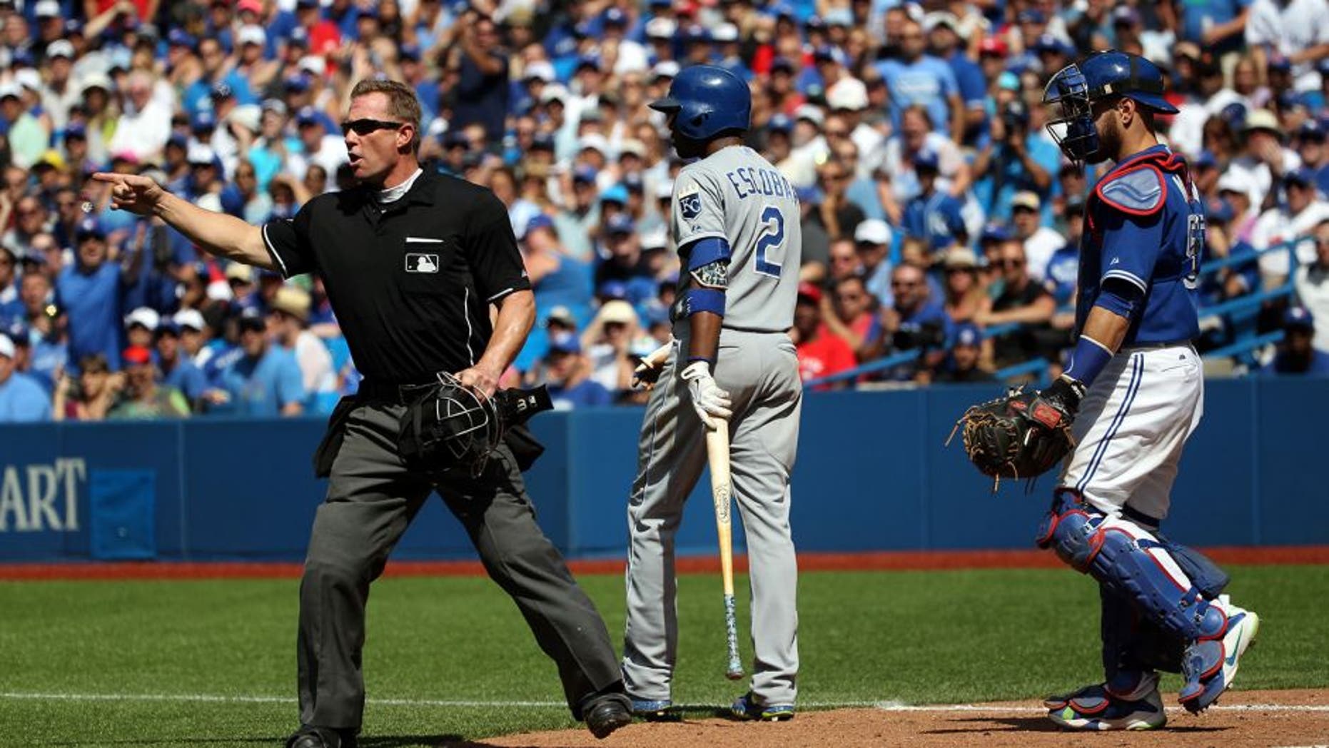 Toronto, Canada - August 2 - Umpire Jim Wolf (28) calls out Toronto Blue Jays starting pitcher Aaron Sanchez (41) for hitting Kansas City Royals shortstop Alcides Escobar (2) with a pitch during MLB action at the Rogers Centre in Toronto on August 2, 2015. (Cole Burston/Toronto Star via Getty Images)