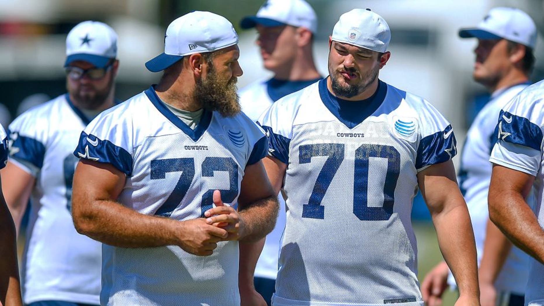 Dallas Cowboys center Travis Frederick (72) and guard Zack Martin (70) take the field for morning practice at NFL football training camp, Tuesday, Aug. 4, 2015, in Oxnard, Calif. (AP Photo/Gus Ruelas)
