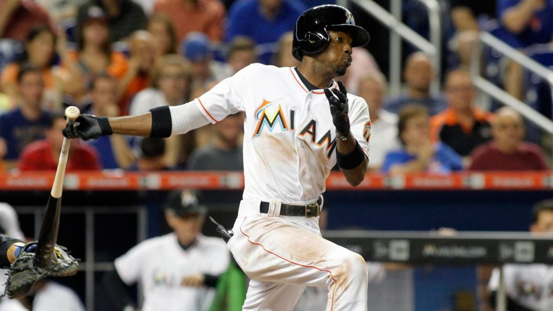 Miami Marlins' Dee Gordon hits an RBI single in the third inning of play against the New York Mets during a baseball game in Miami, Tuesday Aug. 4, 2015. (AP Photo/Joe Skipper)