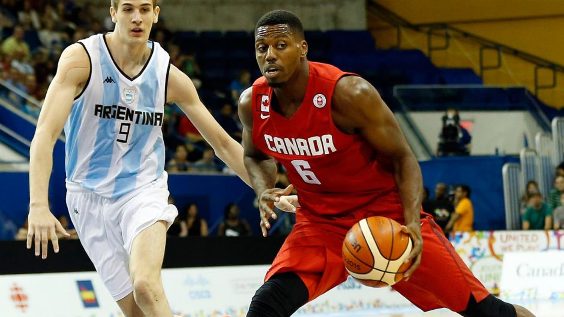 Jul 22, 2015; Toronto, Ontario, CAN; Canada forward Melvin Ejim (6) drives to the basket against Argentina forward Nicolas Brussino (9) in the men's basketball preliminary round during the 2015 Pan Am Games at Ryerson Athletic Centre. Mandatory Credit: Geoff Burke-USA TODAY Sports