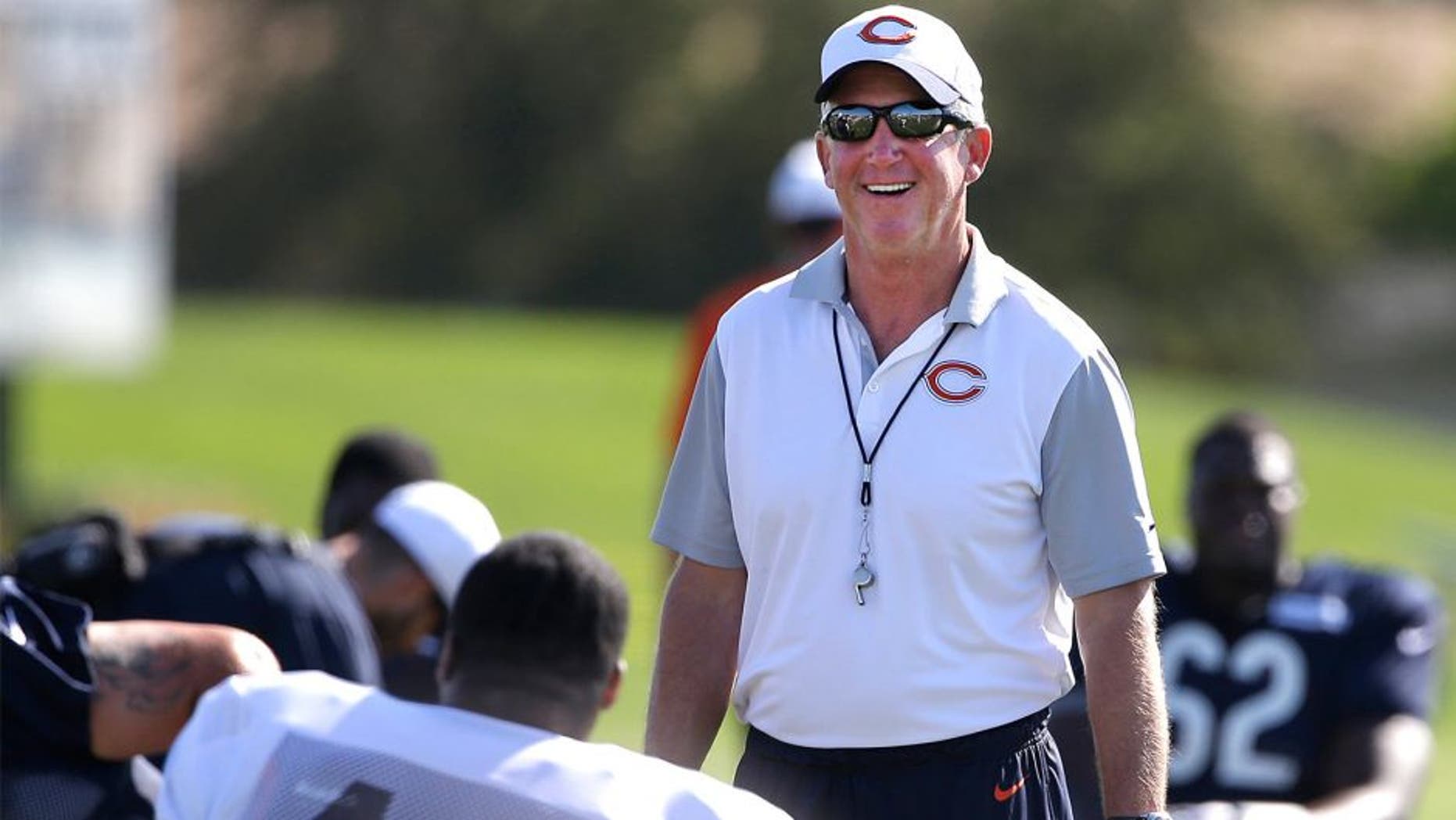 Chicago Bears head coach John Fox smiles as he watches his team during NFL football training camp at Olivet Nazarene University, Saturday, Aug. 1, 2015, in Bourbonnais, Ill. (AP Photo/Nam Y. Huh)