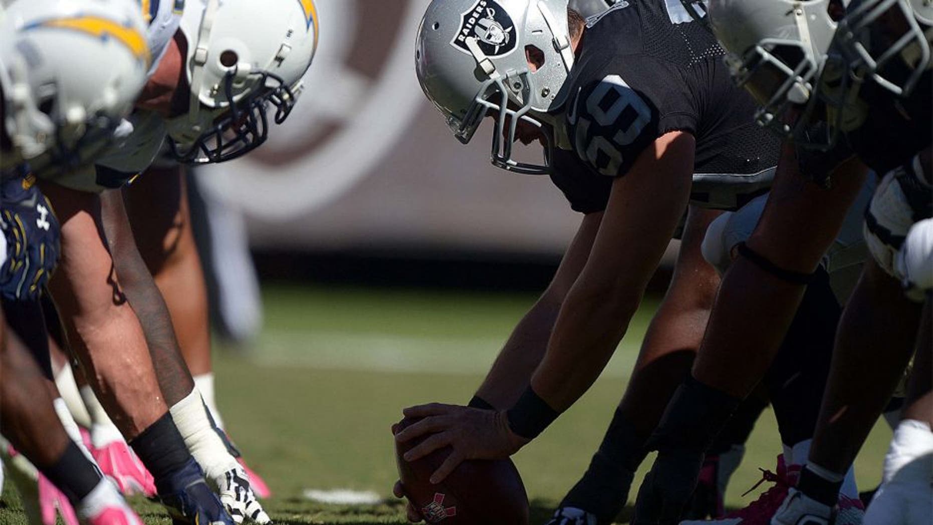 Oct 12, 2014; Oakland, CA, USA; General view of the line of scrimmage as Oakland Raiders long snapper Jon Condo (59) snaps the ball against the San Diego Chargers at O.co Coliseum. Mandatory Credit: Kirby Lee-USA TODAY Sports