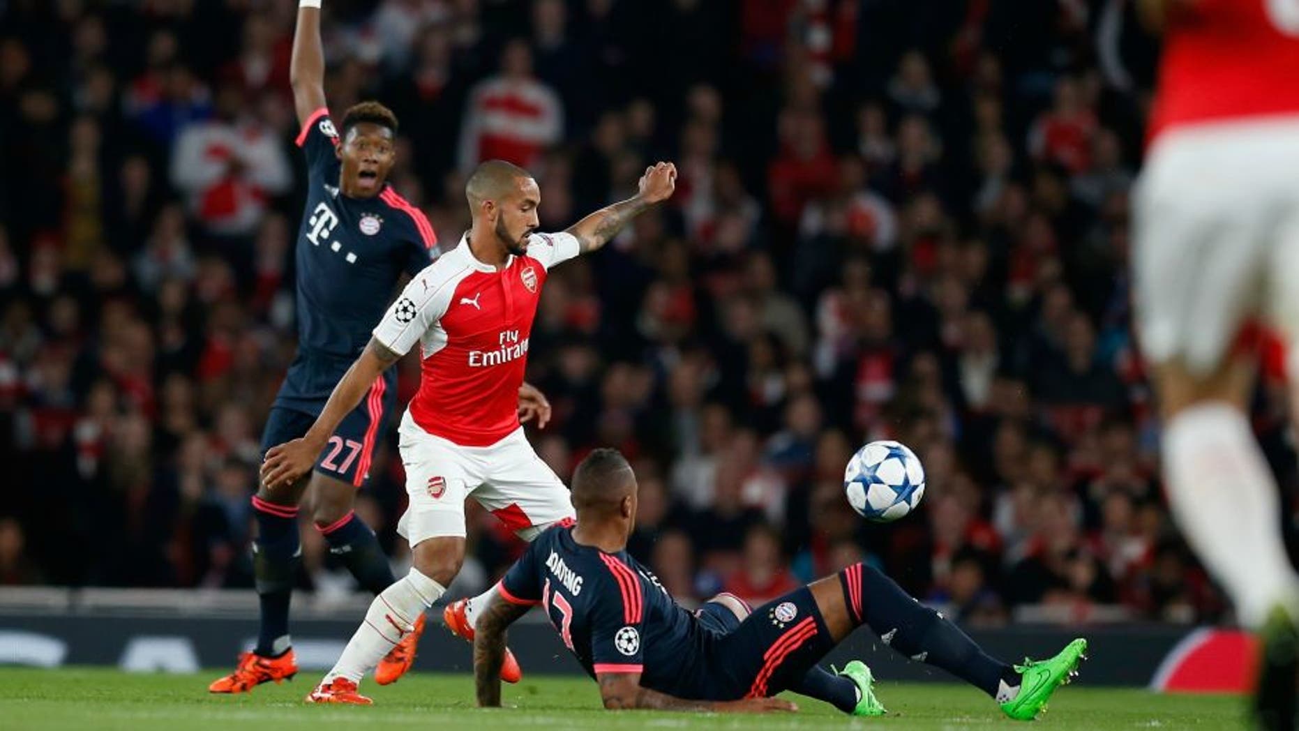 xxx of Arsenal is challenged by yyy of Bayern Munchen during the UEFA Champions League Group F match between Arsenal FC and FC Bayern Munchen at the Emirates Stadium on October 20, 2015 in London, United Kingdom.