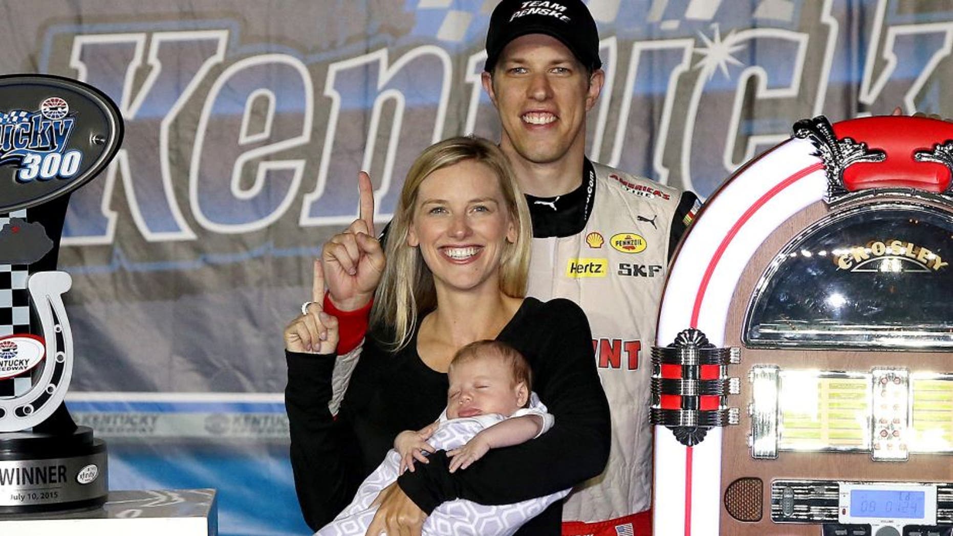 SPARTA, KY - JULY 10: Brad Keselowski, driver of the #22 Discount Tire Ford, poses with girlfriend Paige White and their daughter in Victory Lane after winning the NASCAR XFINITY Series Kentucky 300 at Kentucky Speedway on July 10, 2015 in Sparta, Kentucky. (Photo by Sean Gardner/NASCAR via Getty Images)