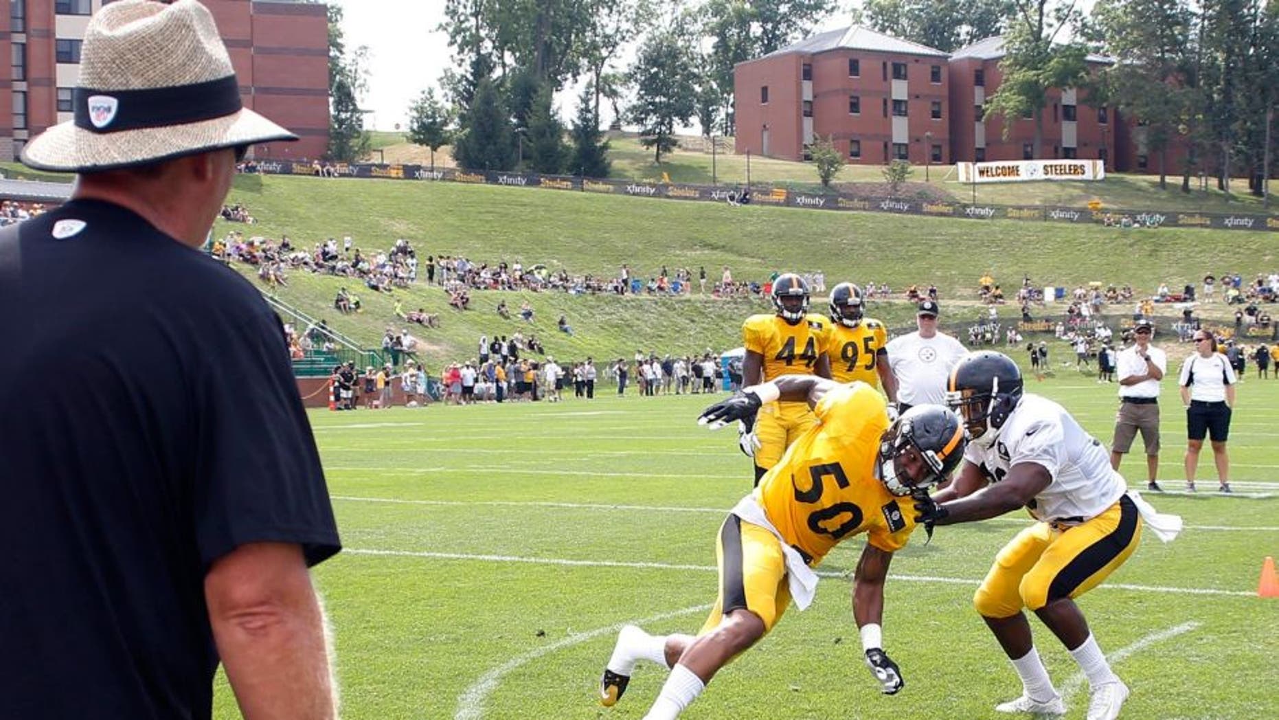Pittsburgh Steelers defensive coordinator Keith Butler, left, watches as inside linebacker Ryan Shazier (50) works on running back Cameron Stingly during a drill at NFL football training camp, Wednesday, July 29, 2015, in Latrobe, Pa. (AP Photo/Keith Srakocic)