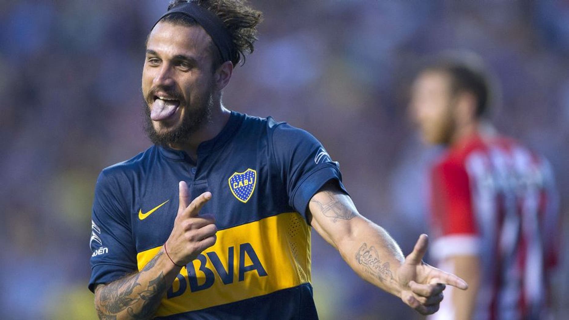 Boca Juniors' forward Daniel Osvaldo (L) celebrates after scoring the team's second goal against Estudiantes during their Argentina First Division football match at La Bombonera stadium in Buenos Aires, Argentina, on March 29, 2015. AFP PHOTO / ALEJANDRO PAGNI (Photo credit should read ALEJANDRO PAGNI/AFP/Getty Images)