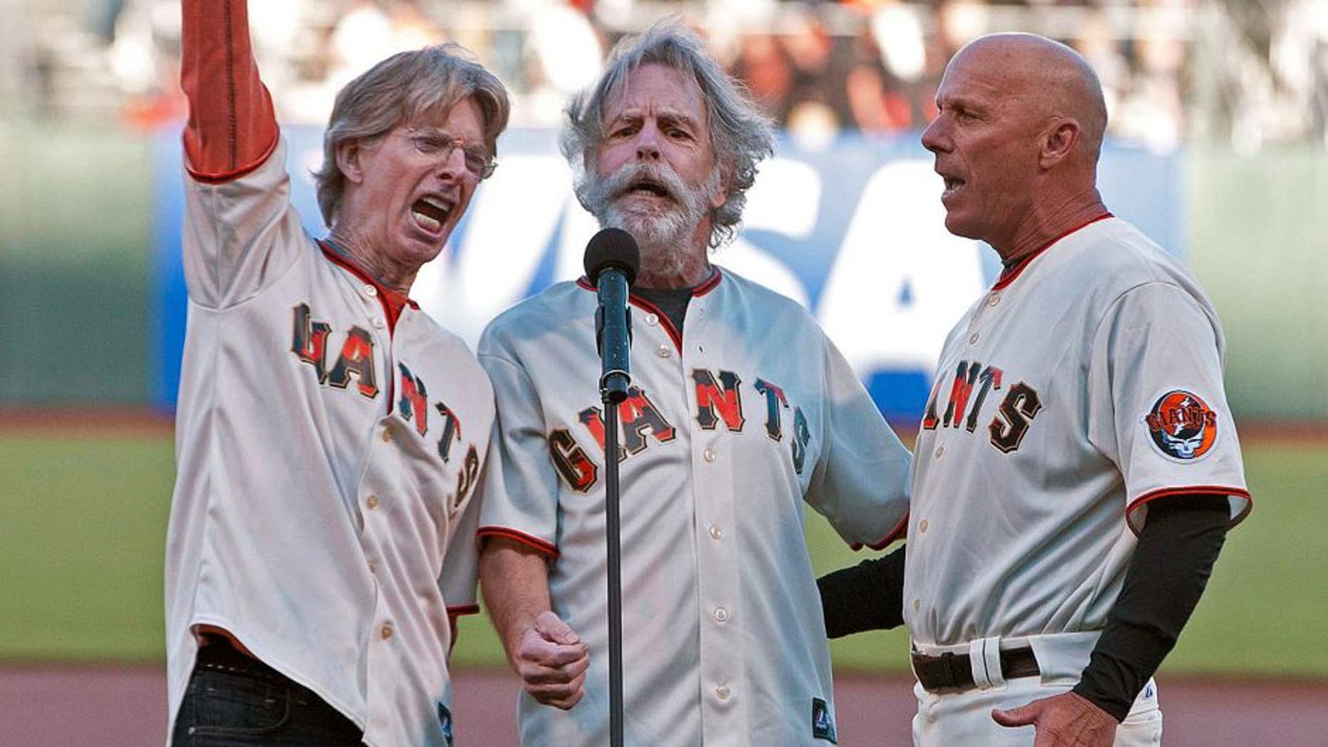 August 9, 2011; San Francisco, CA, USA; Grateful Dead band members Phil Lesh (left) and Bob Weir (center) sing the national anthem with San Francisco Giants third base coach Tim Flannery (right) before the game against the Pittsburgh Pirates at AT&T Park. Mandatory Credit: Jason O. Watson-USA TODAY Sports