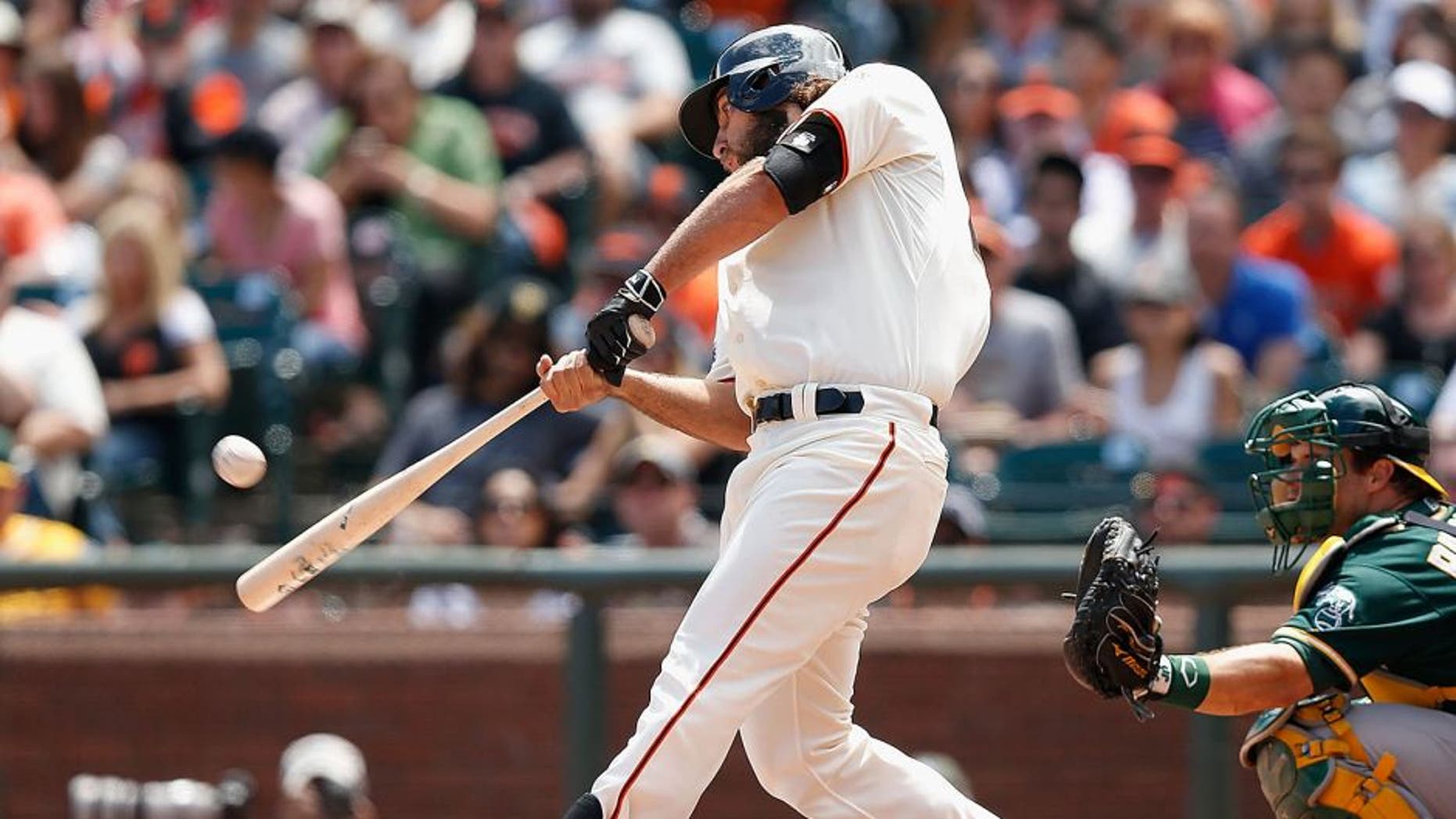SAN FRANCISCO, CA - JULY 25: Madison Bumgarner #40 of the San Francisco Giants hits a solo home run in the third inning against the Oakland Athletics at AT&T Park on July 25, 2015 in San Francisco, California. (Photo by Lachlan Cunningham/Getty Images)